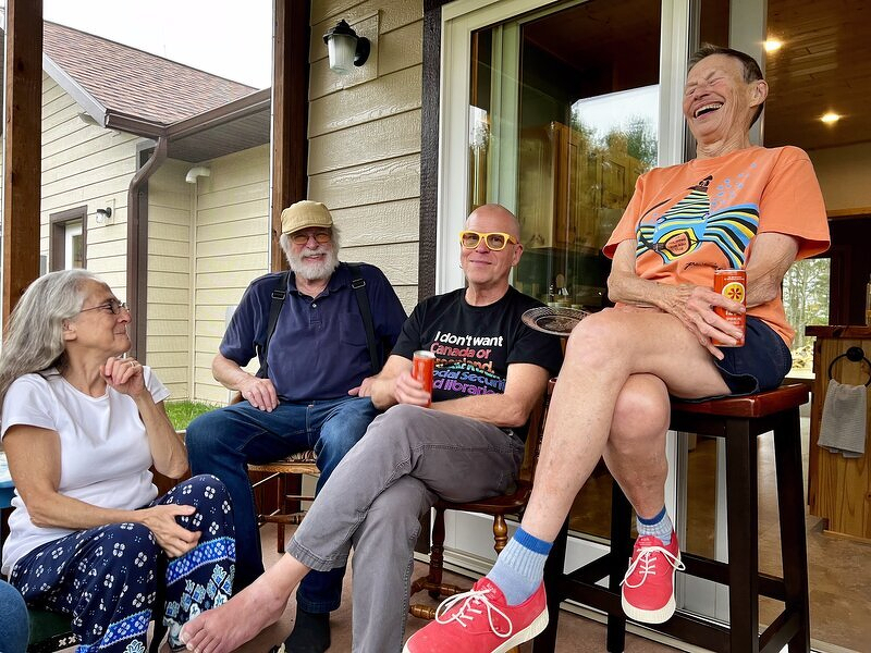Friends laughing together in Carolyn's new screen porch