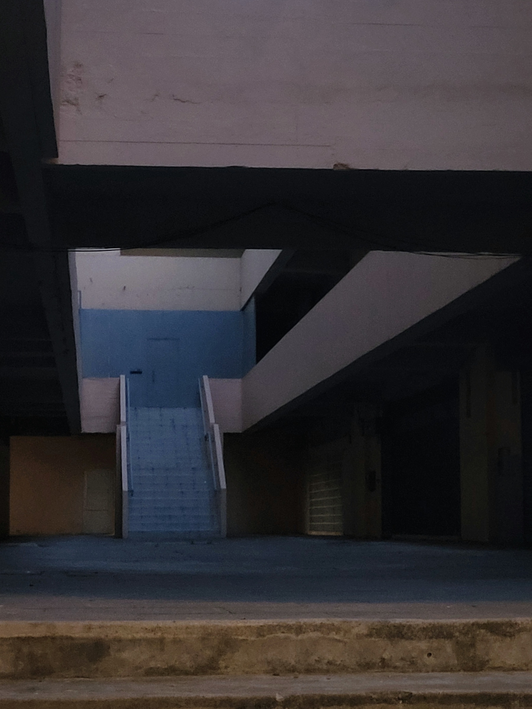 dimly lit hallway with stairs