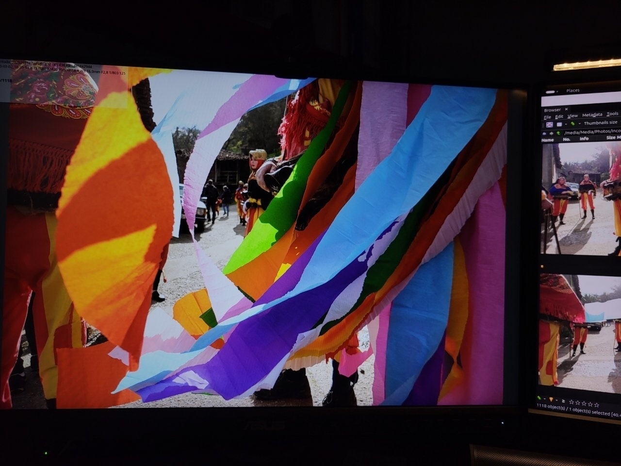 Colorful streamers are hung outdoors, with people and structures visible in the background.