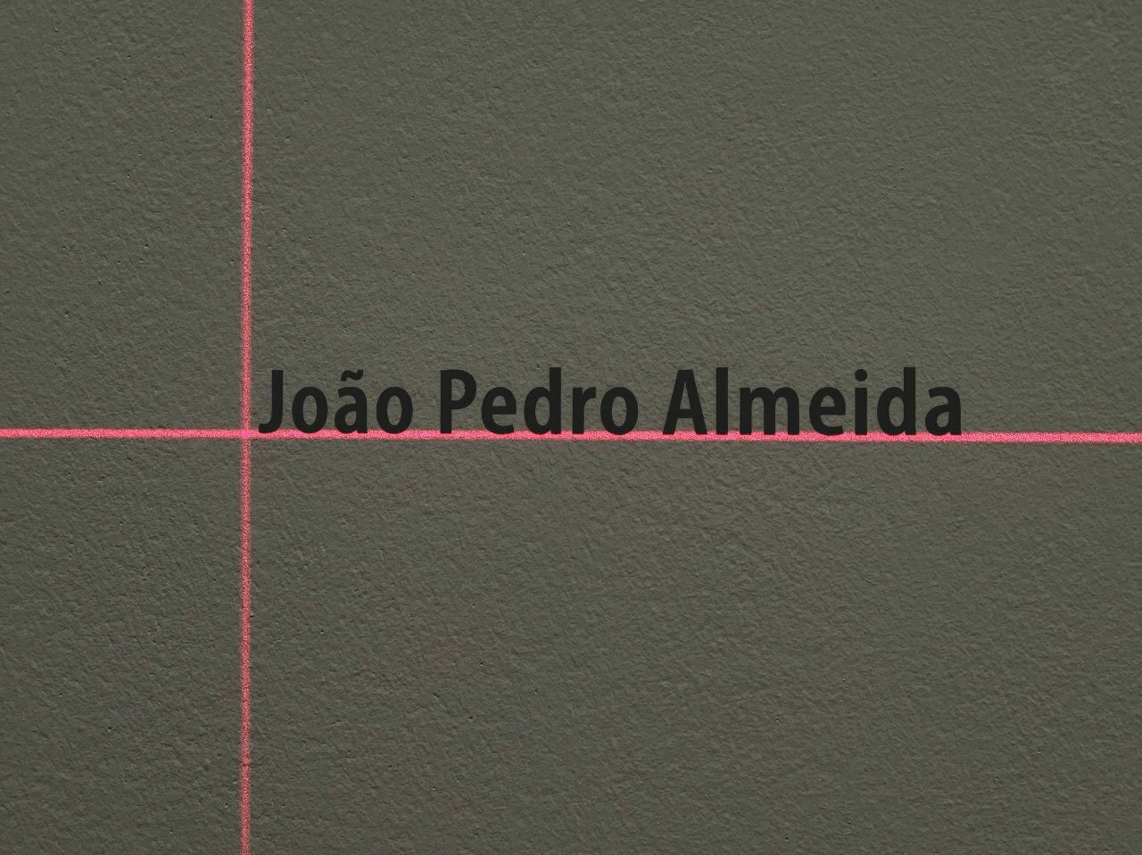 A dark surface with a red cross, intersecting behind the text João Pedro Almeida.
