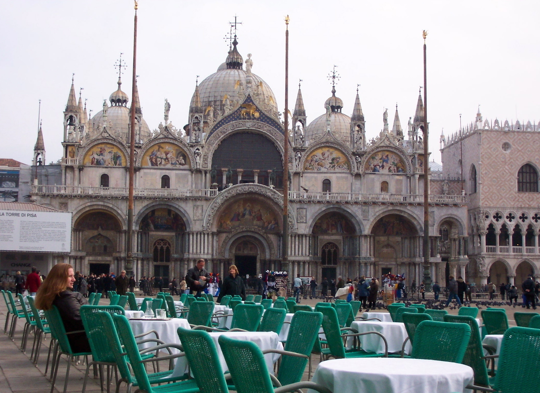 Woman seated outside cafe on Piazza San Marco
