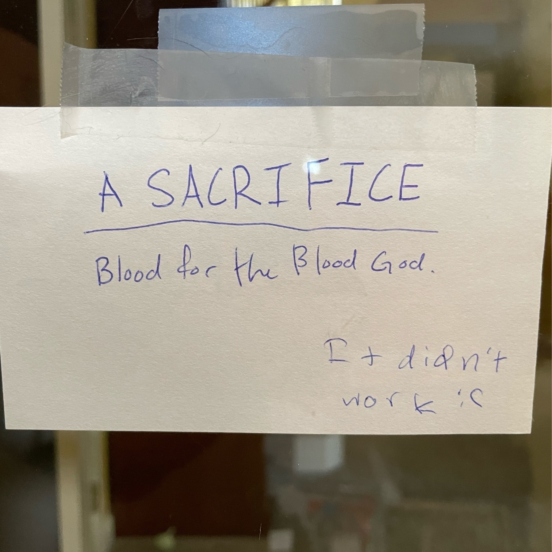 Handmade sign reading: A Sacrifice; Blood for the Blood God. Then in the lower right corner: It didn't work.
