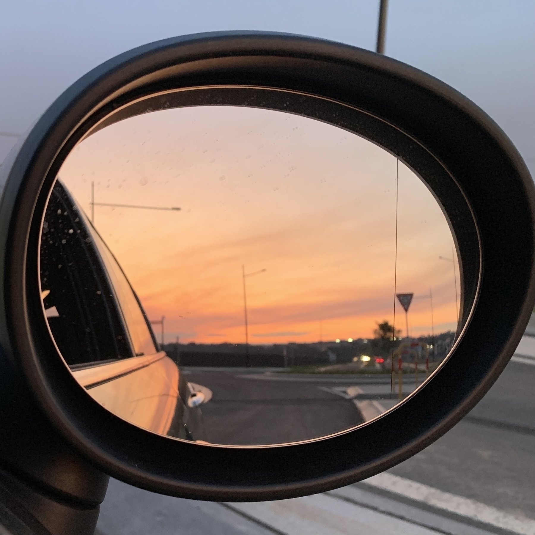 Looking back at the sunset in the side mirror of my mum’s sporty little Mini