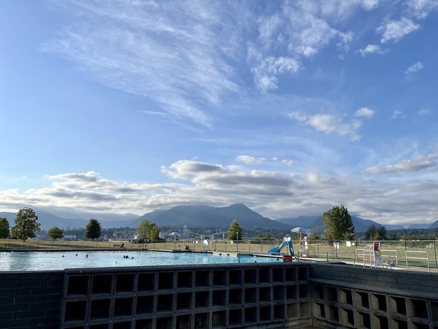 View from the change rooms over the pool and across to the North Shore mountains. Amazing blue skies with whispy clouds 