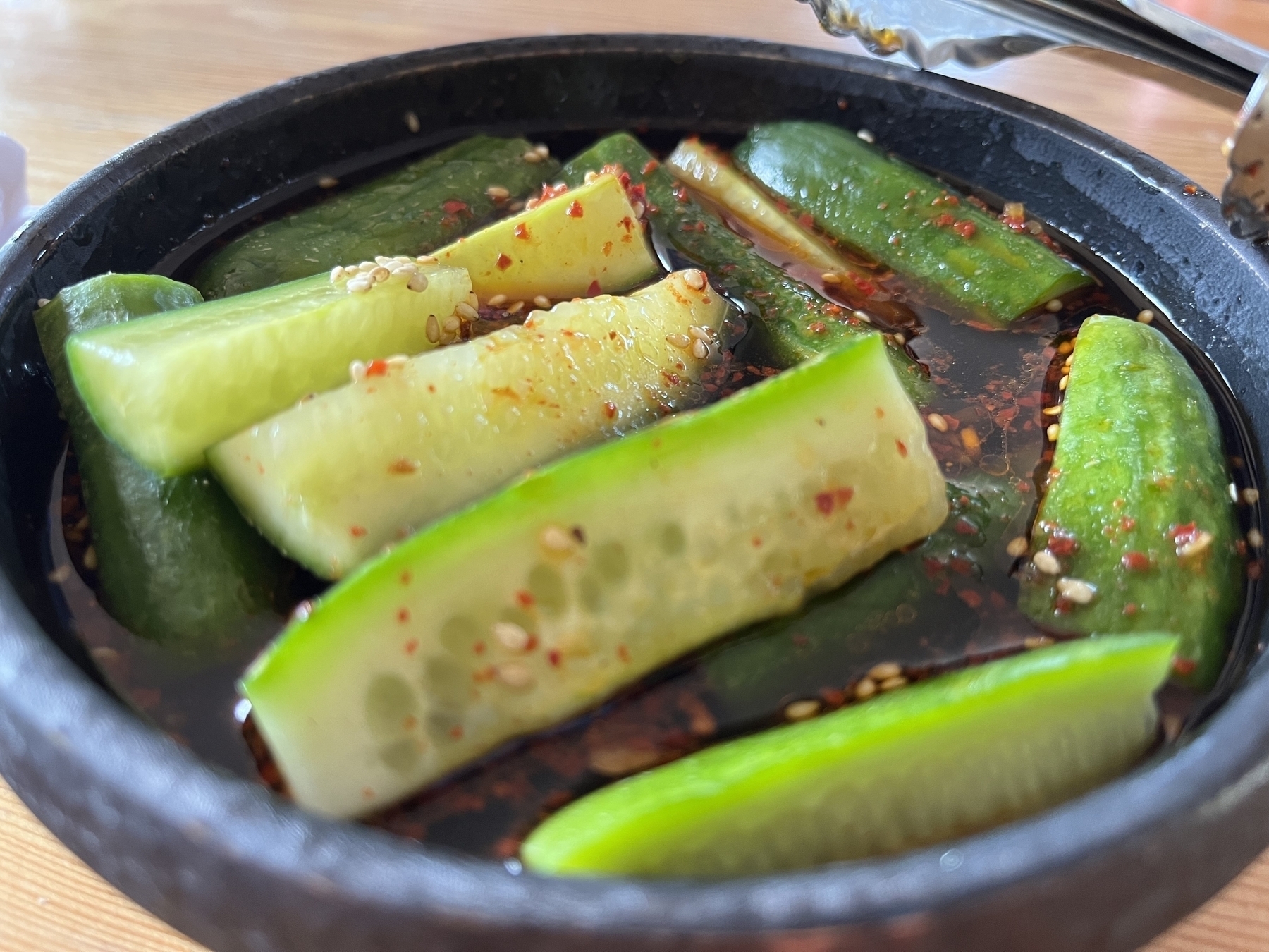 Cucumbers with gochujang sauce and roasted sesame seeds.
