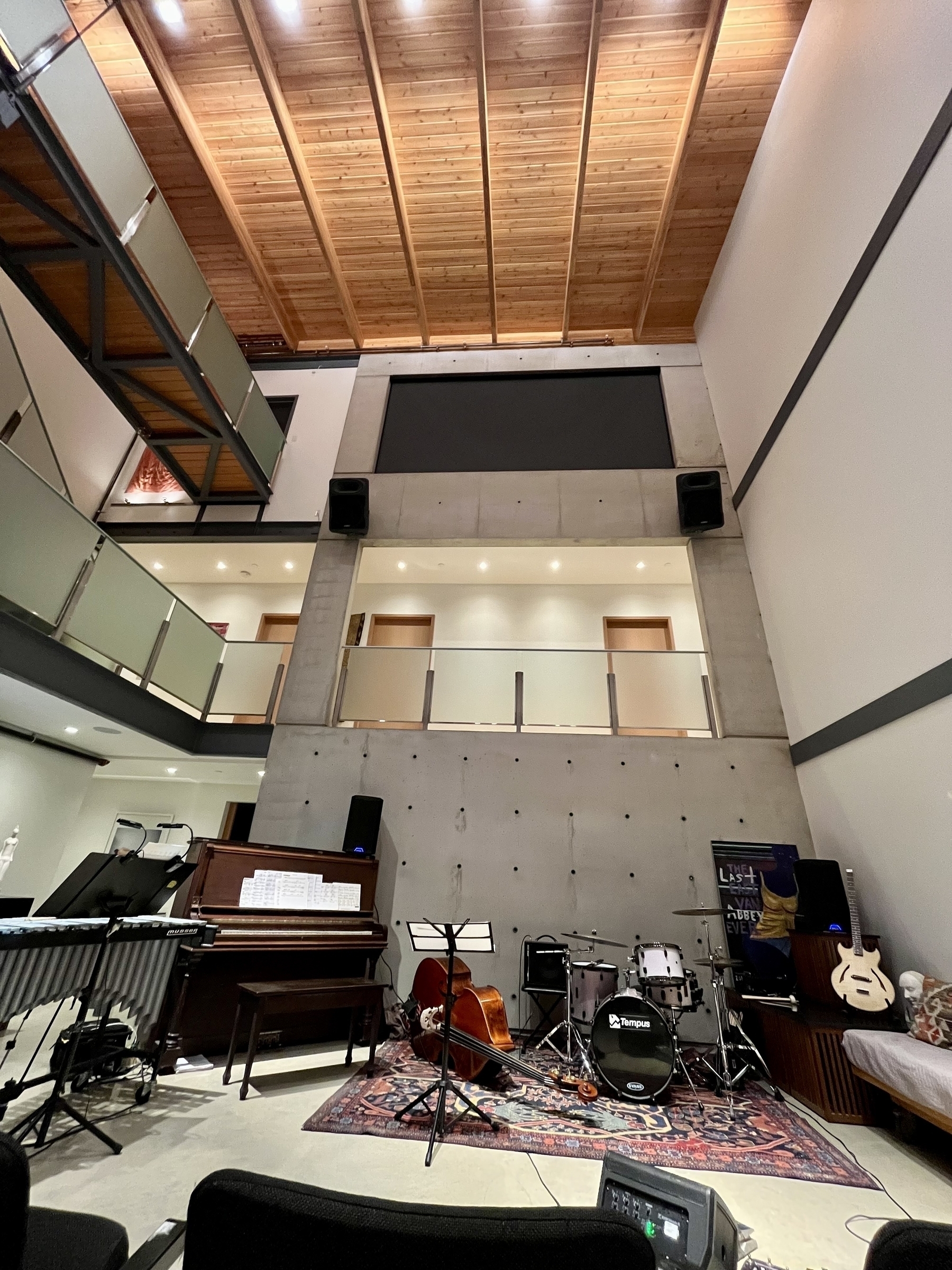 Wide angle of a music stage setup with a unique concrete and wood high ceilinged space 
