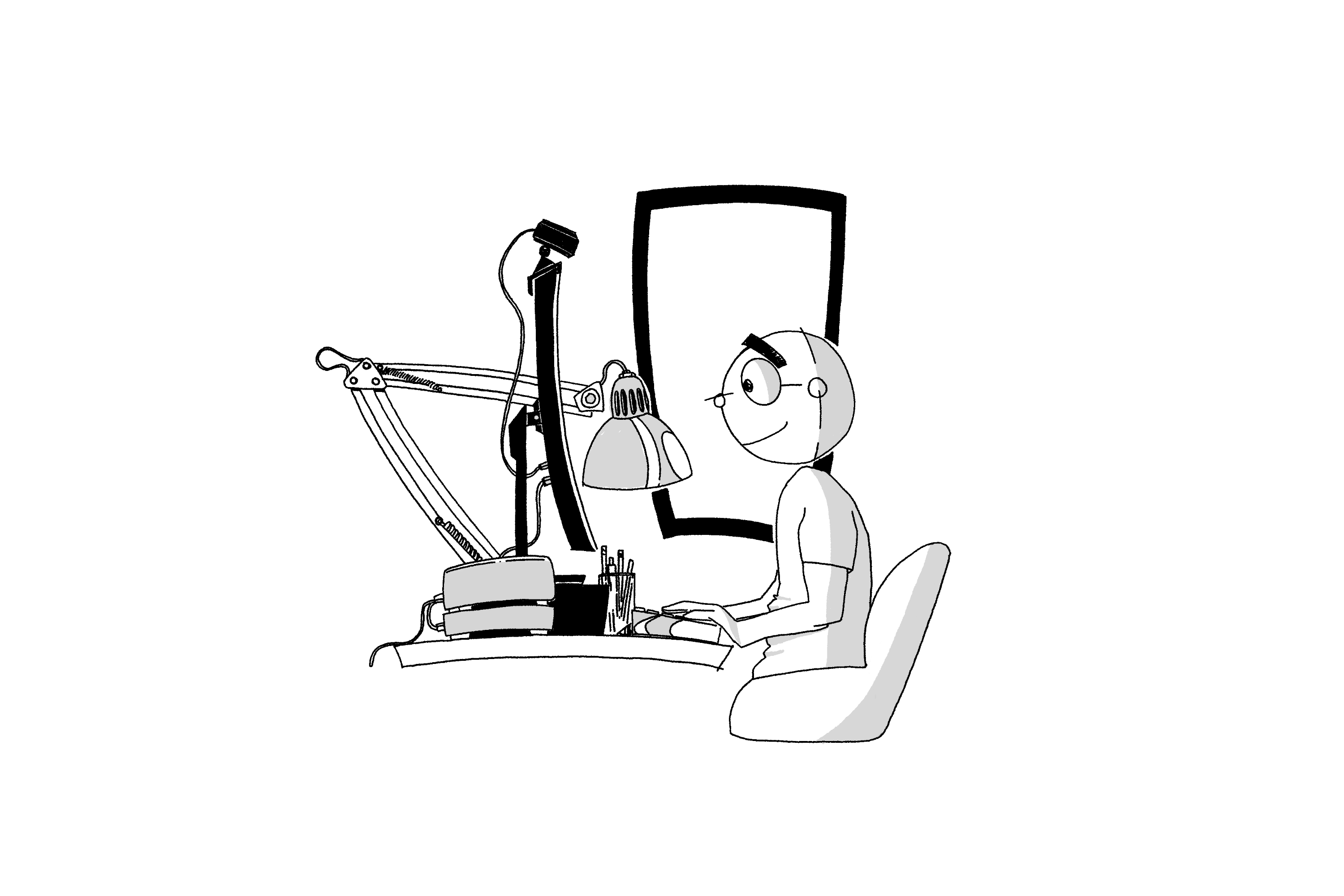 A person sitting at a desk, working on a computer with a lamp overhead.