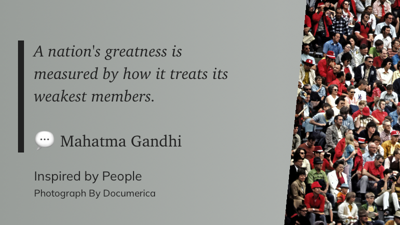 A quote by Mahatma Gandhi about a nation's greatness is accompanied by a photograph of a large, diverse crowd.