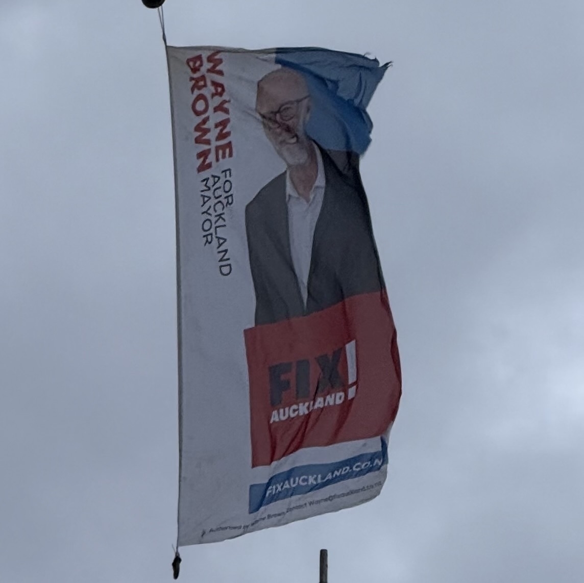 🔗 A flag flying atop a crane in Three Lamps, Auckland