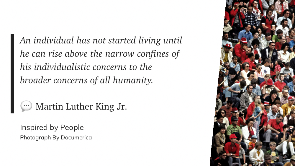 A quote by Martin Luther King Jr. is displayed beside a crowd of people in a stadium.