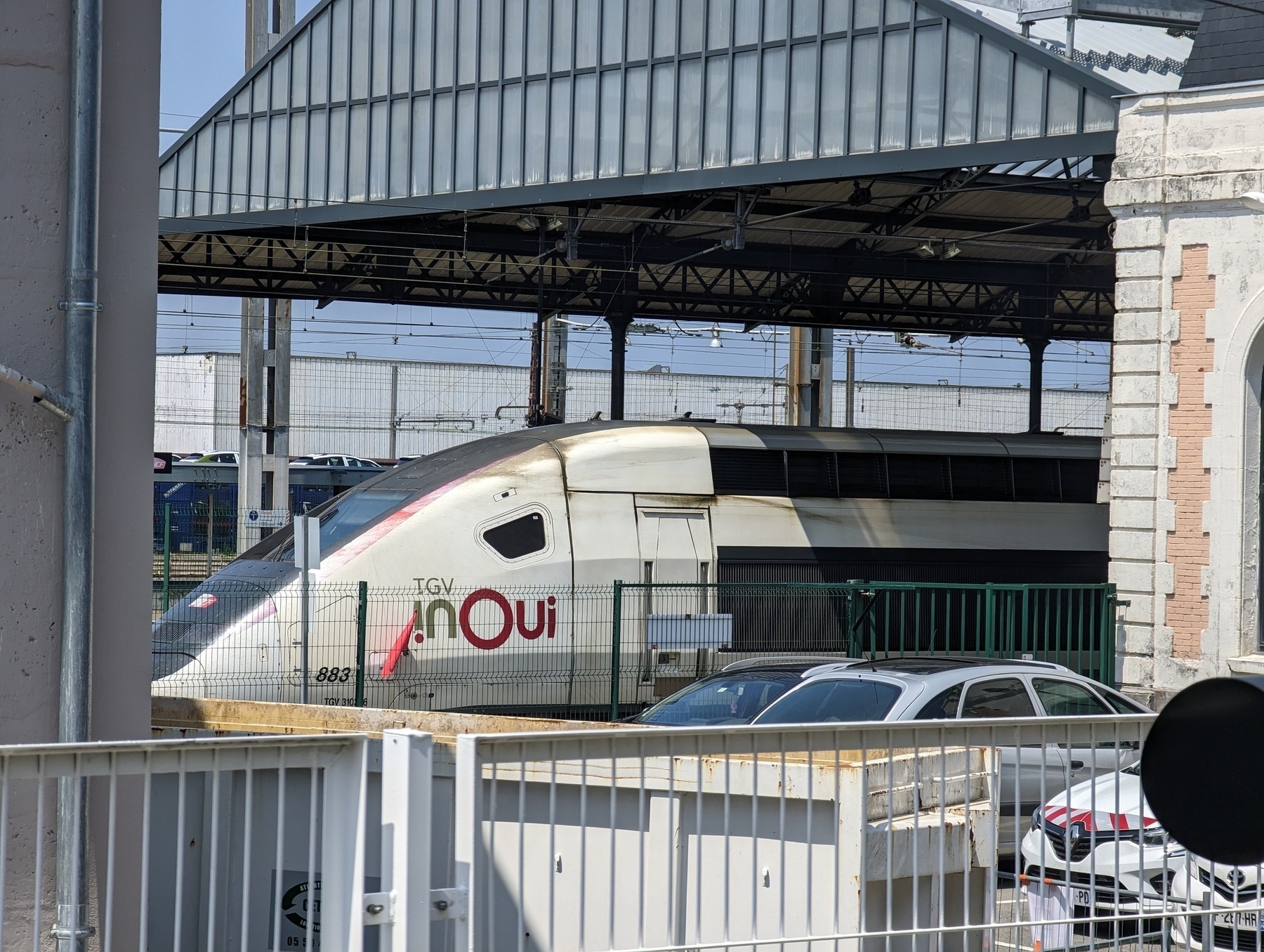 Front of a TGV locomotive with livery Inoui under the canopy of Hendaye station.