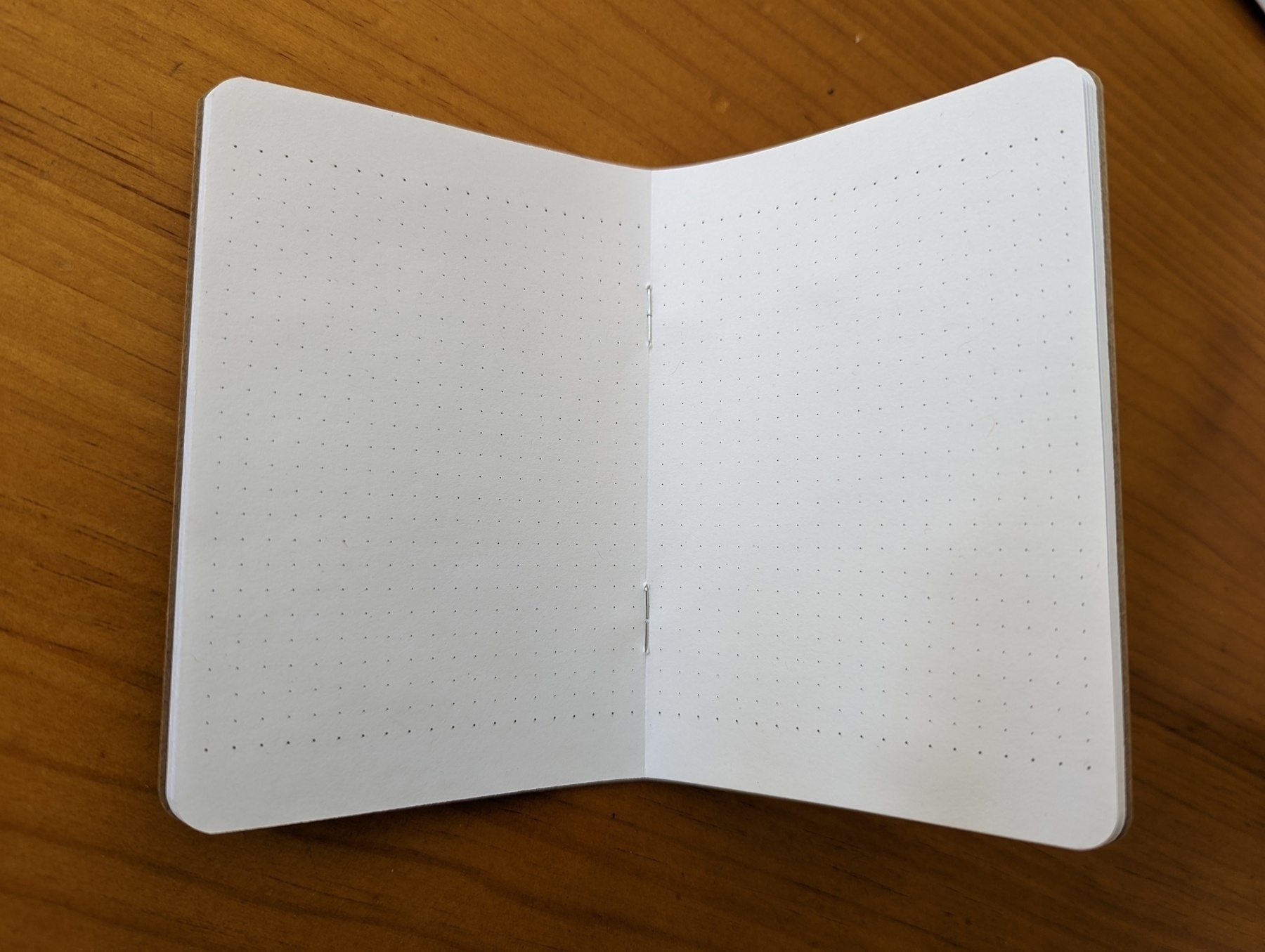Notebook opened to page of empty grid paper