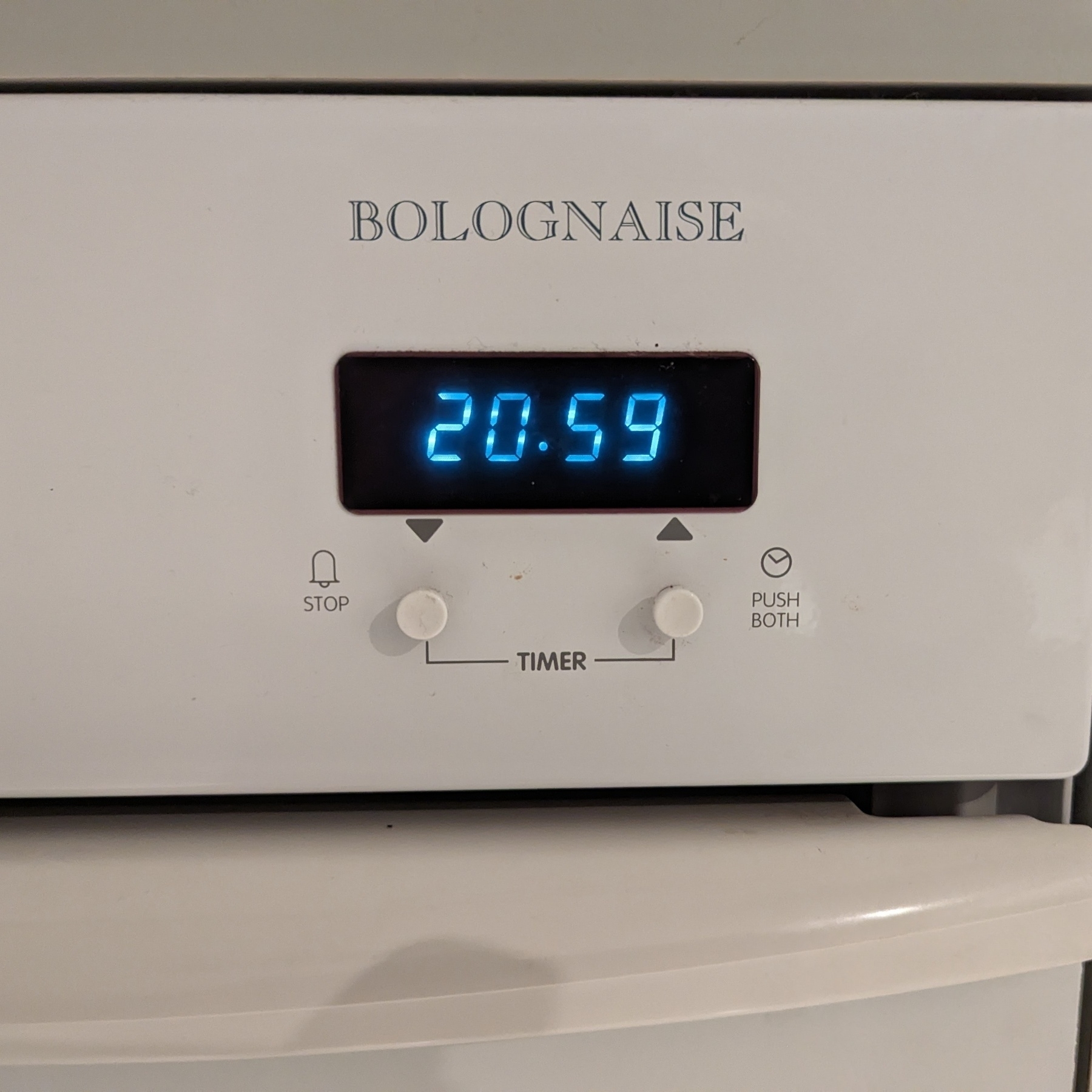 A digital oven clock that reads 20:59.