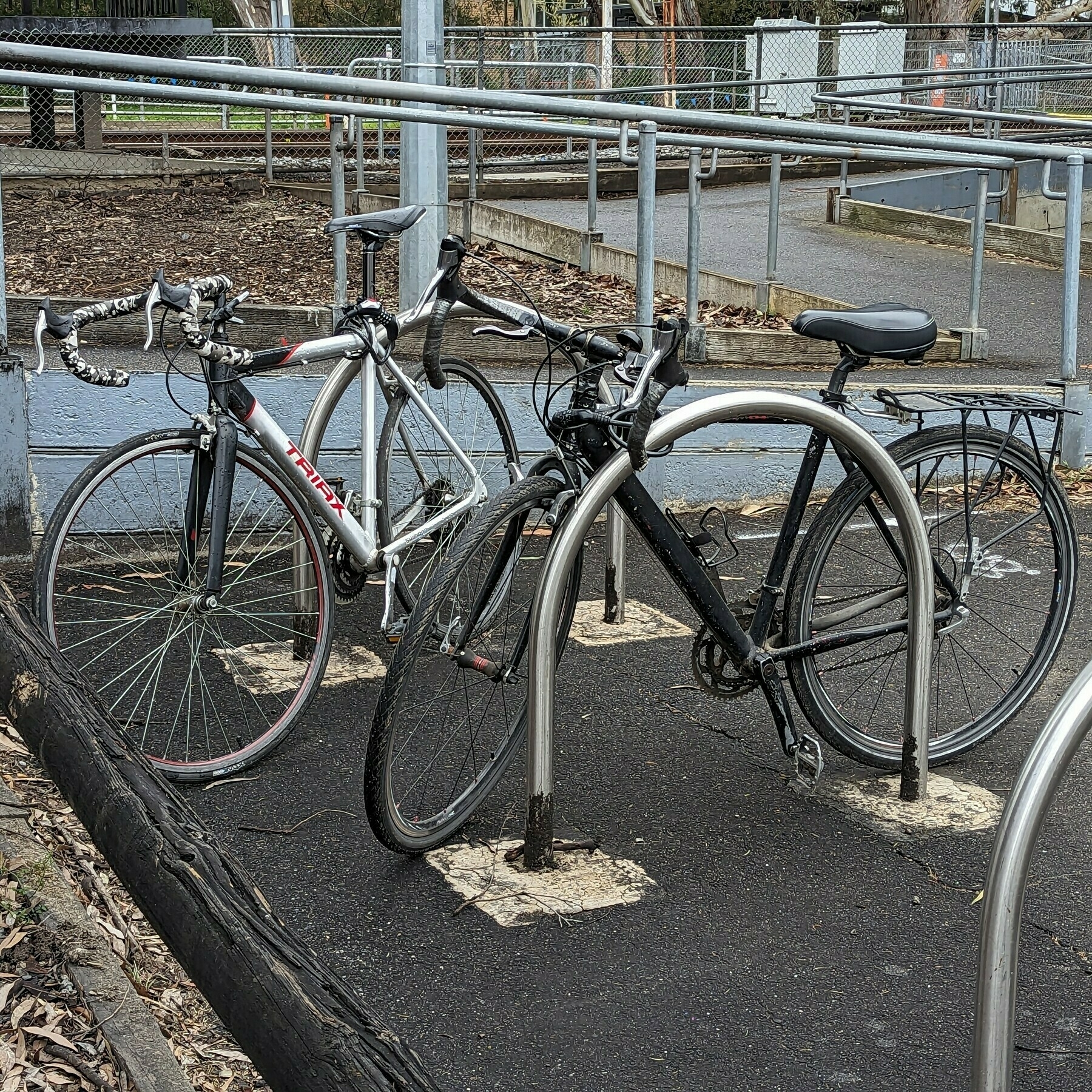 Two bicycles at a bike rack.