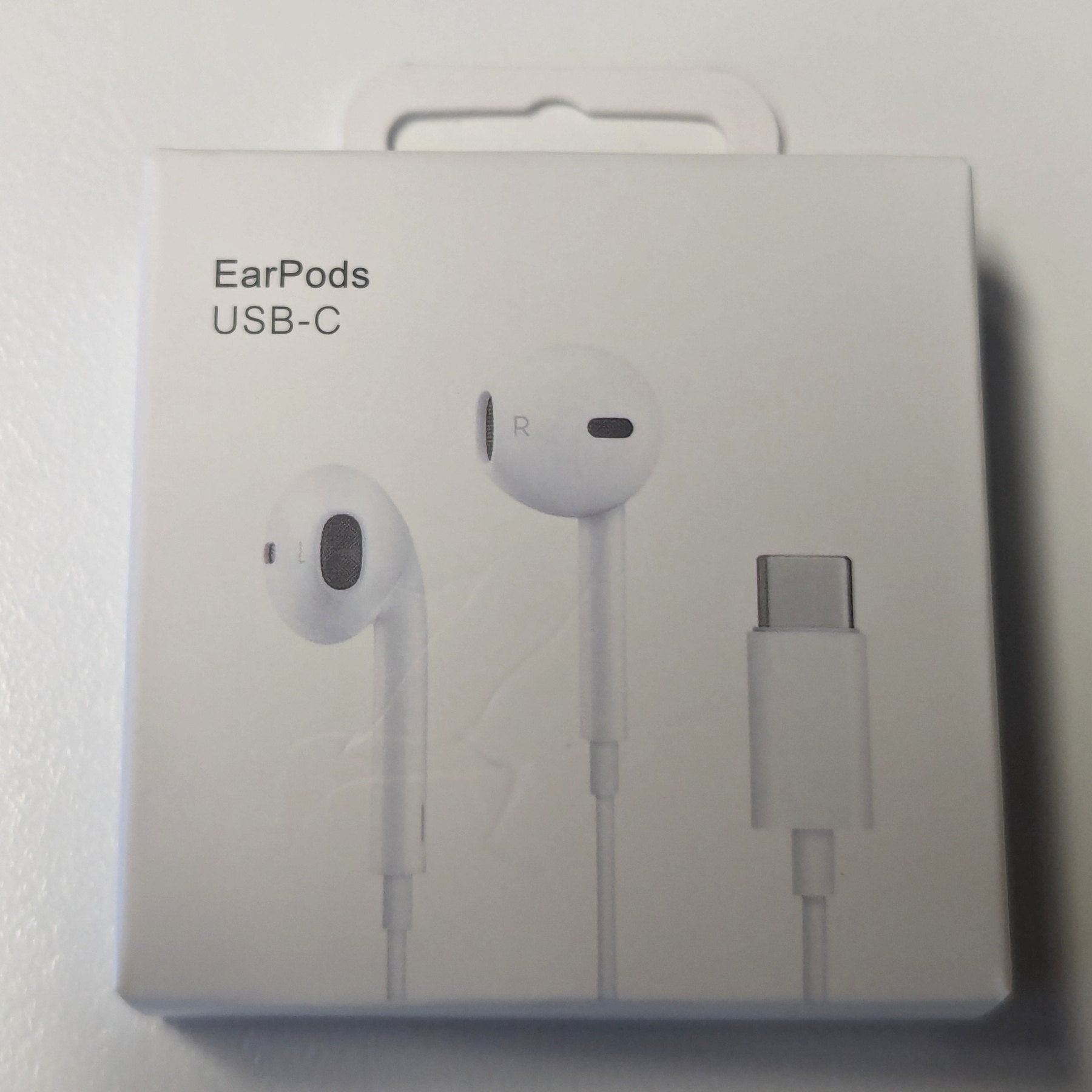 A box of white USB-C earbuds in a box with the name EarPods.