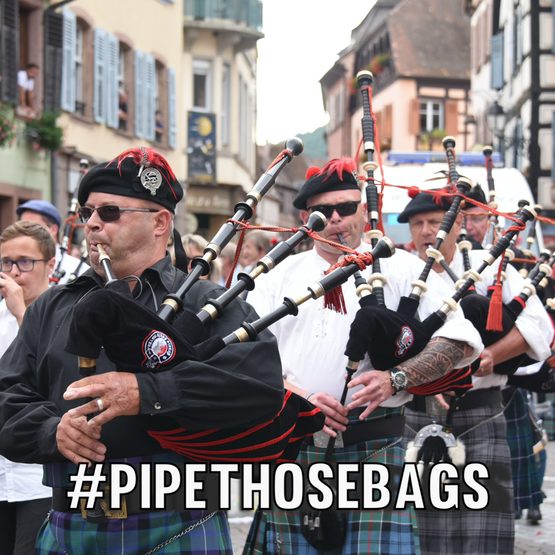 Sock photo of bagpipe players on a British town with the caption ‘#pipe_those_bags’ near the bottom.