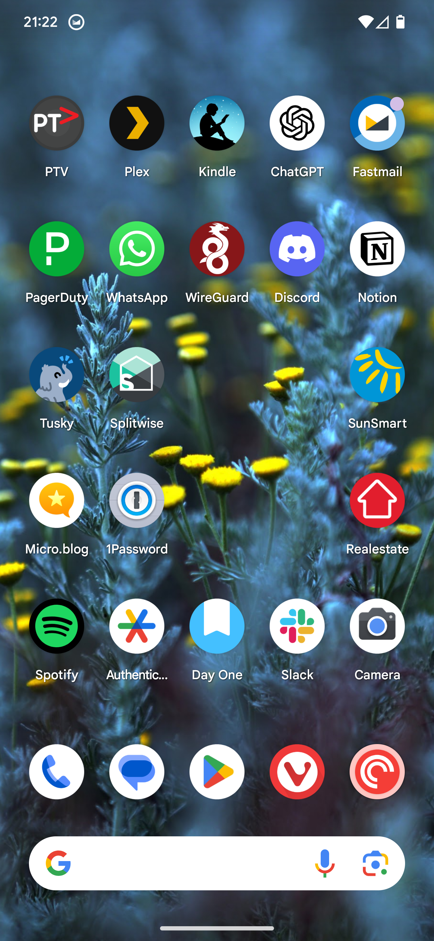 Auto-generated description: A smartphone screen displays various app icons arranged in a grid over a floral background.