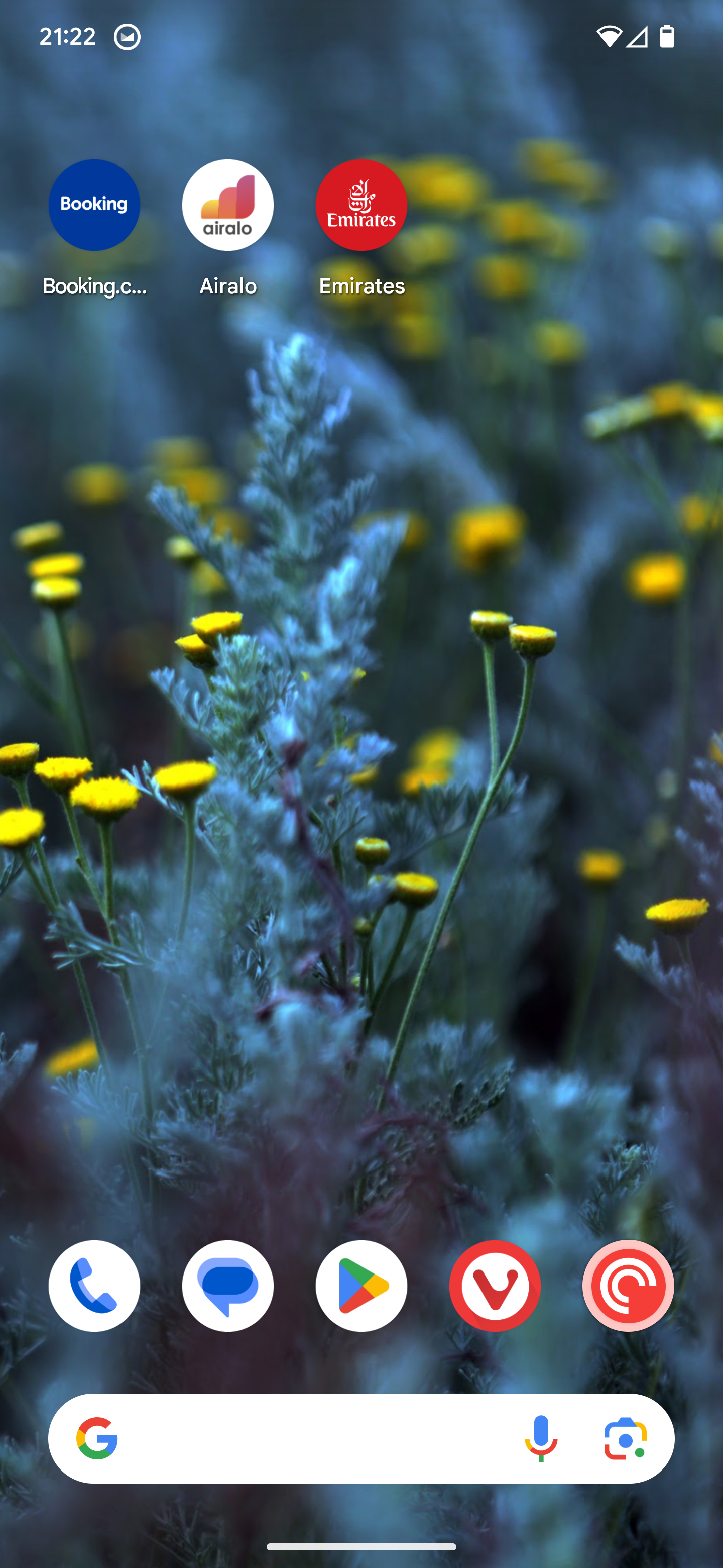 Auto-generated description: A smartphone home screen displays a vibrant wallpaper of yellow flowers and foliage, with apps like Booking, Airalo, and Emirates icons visible at the top.