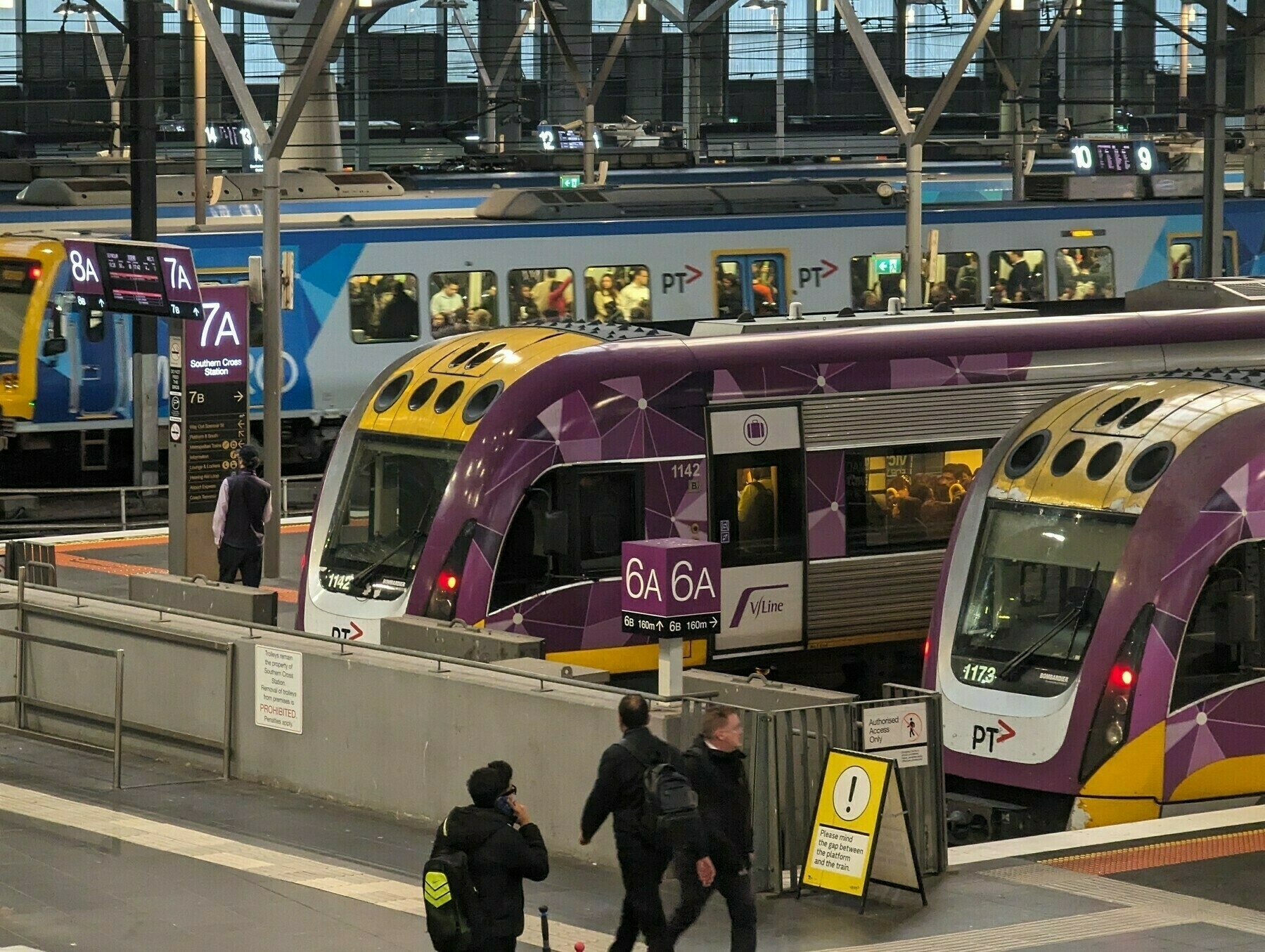 Velocity trains at the platforms of South Cross station, with a Metro train departing in the background 