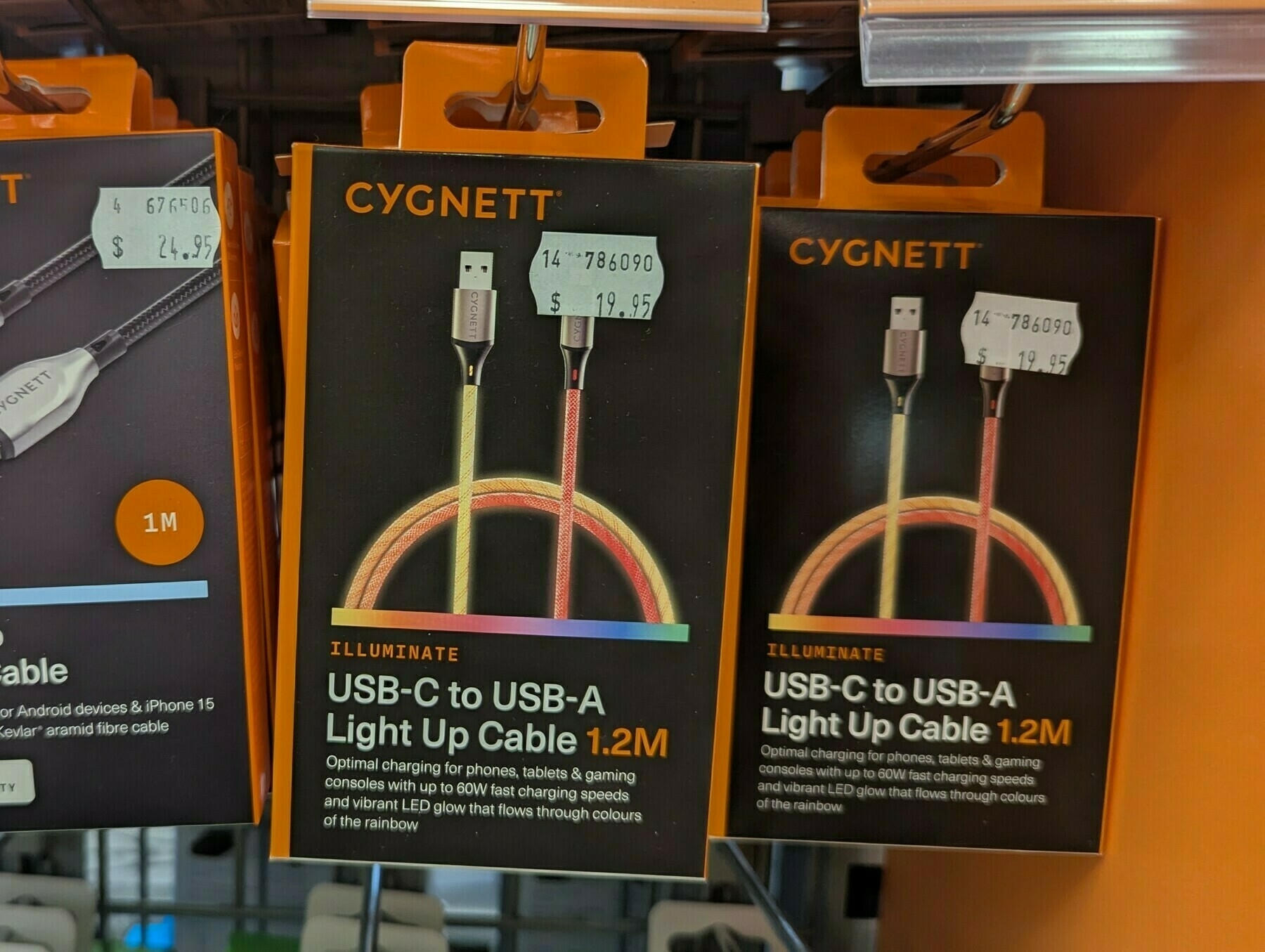 A display shows packages of CYGNETT USB-C to USB-A light-up cables in various lengths for sale.