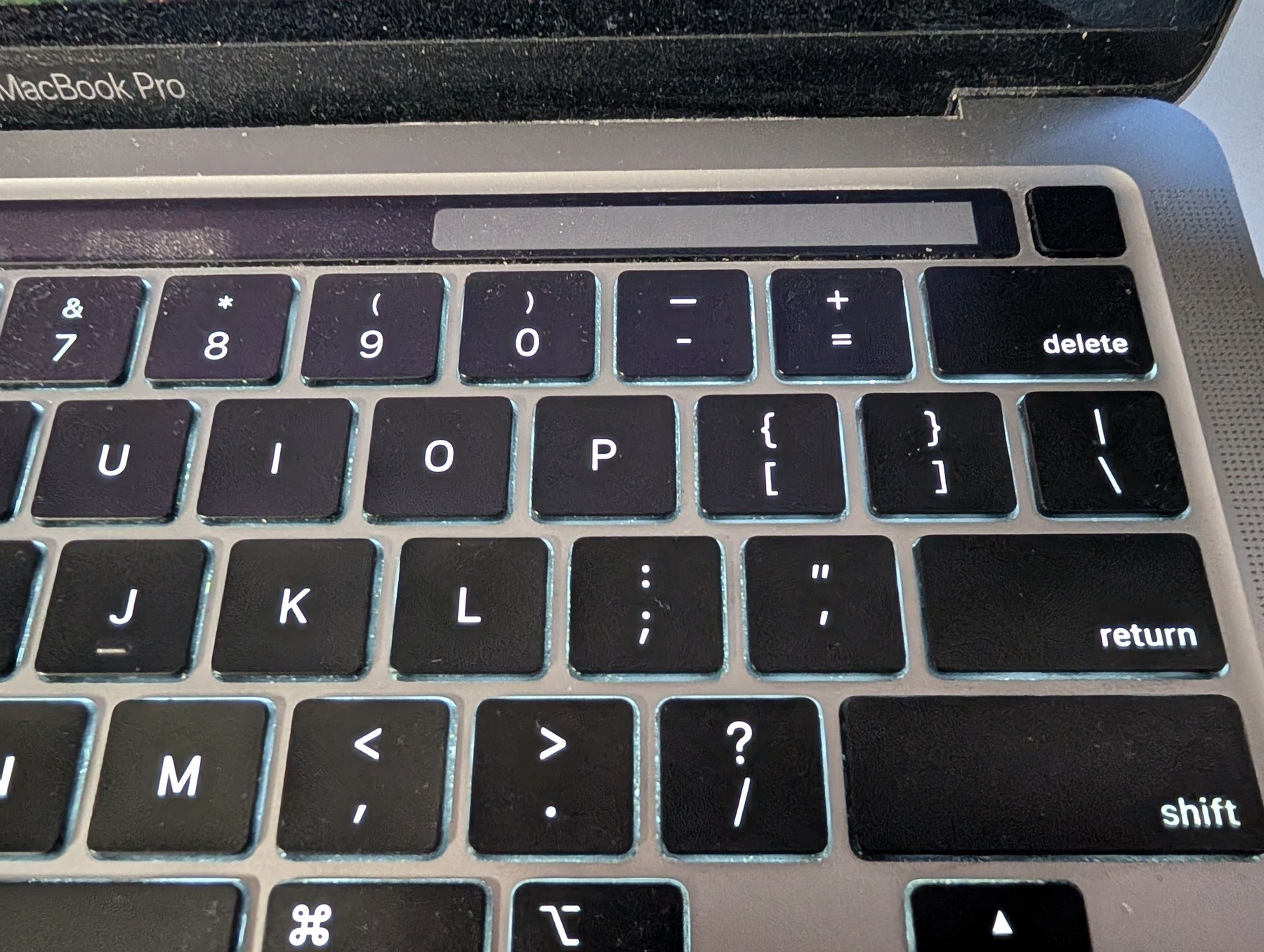 Auto-generated description: A close-up view of a MacBook Pro keyboard highlighting the numeric and character keys.