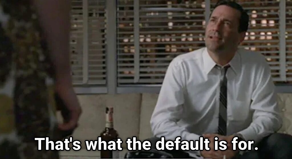 Auto-generated description: A man in an office setting sits on a couch next to a bottle, with the text That's what the default is for.