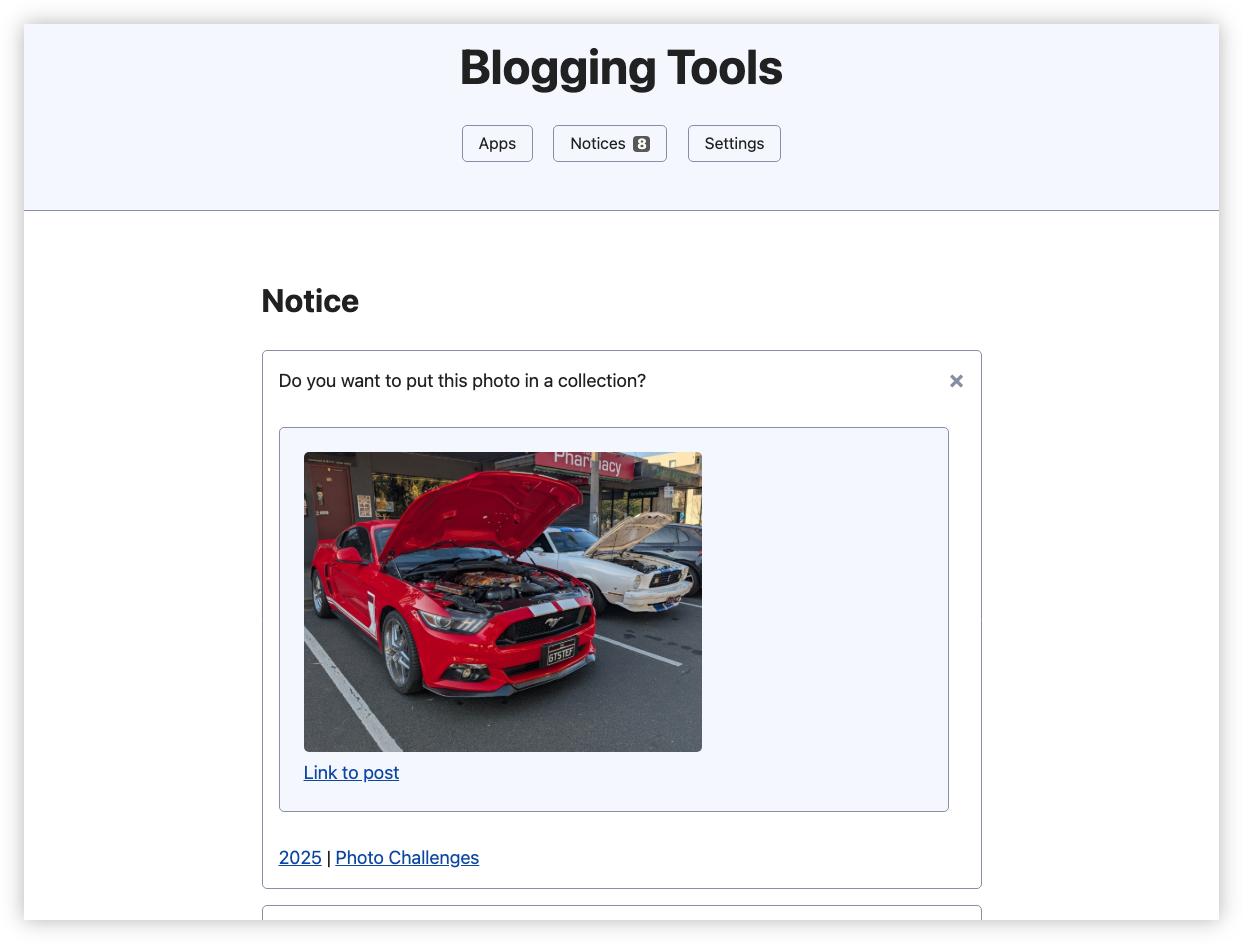 Auto-generated description: A blogging tools interface displays a notice with an image of a parked red car with its hood open next to a white car.