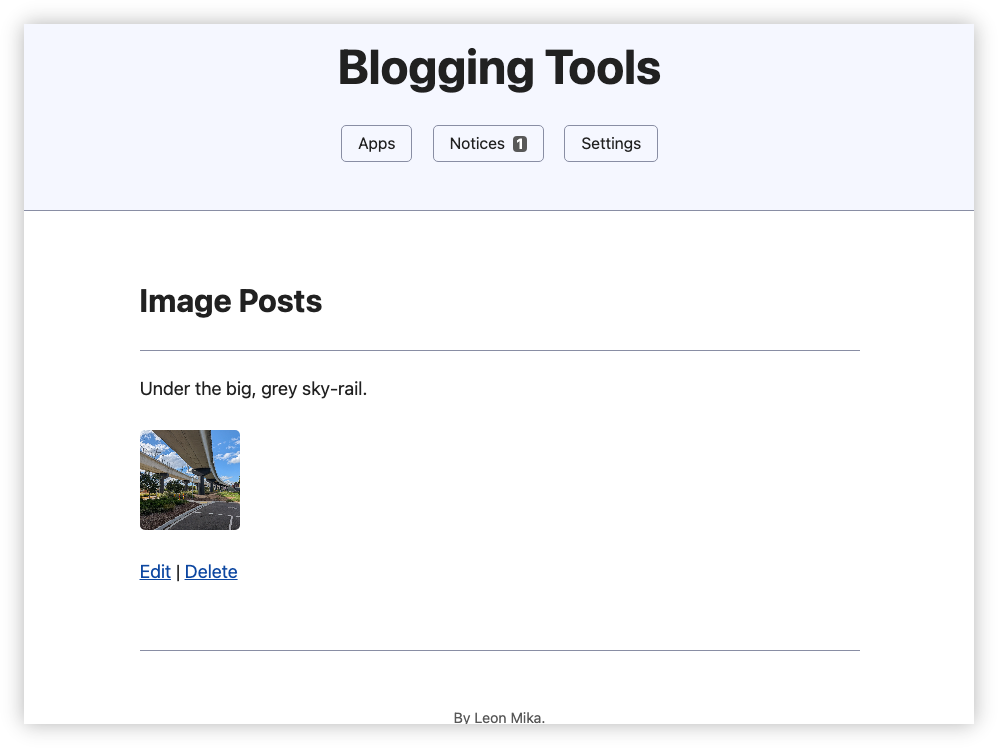 Auto-generated description: Blogging interface featuring a post titled Under the big, grey sky-rail with a small image and options to edit or delete.