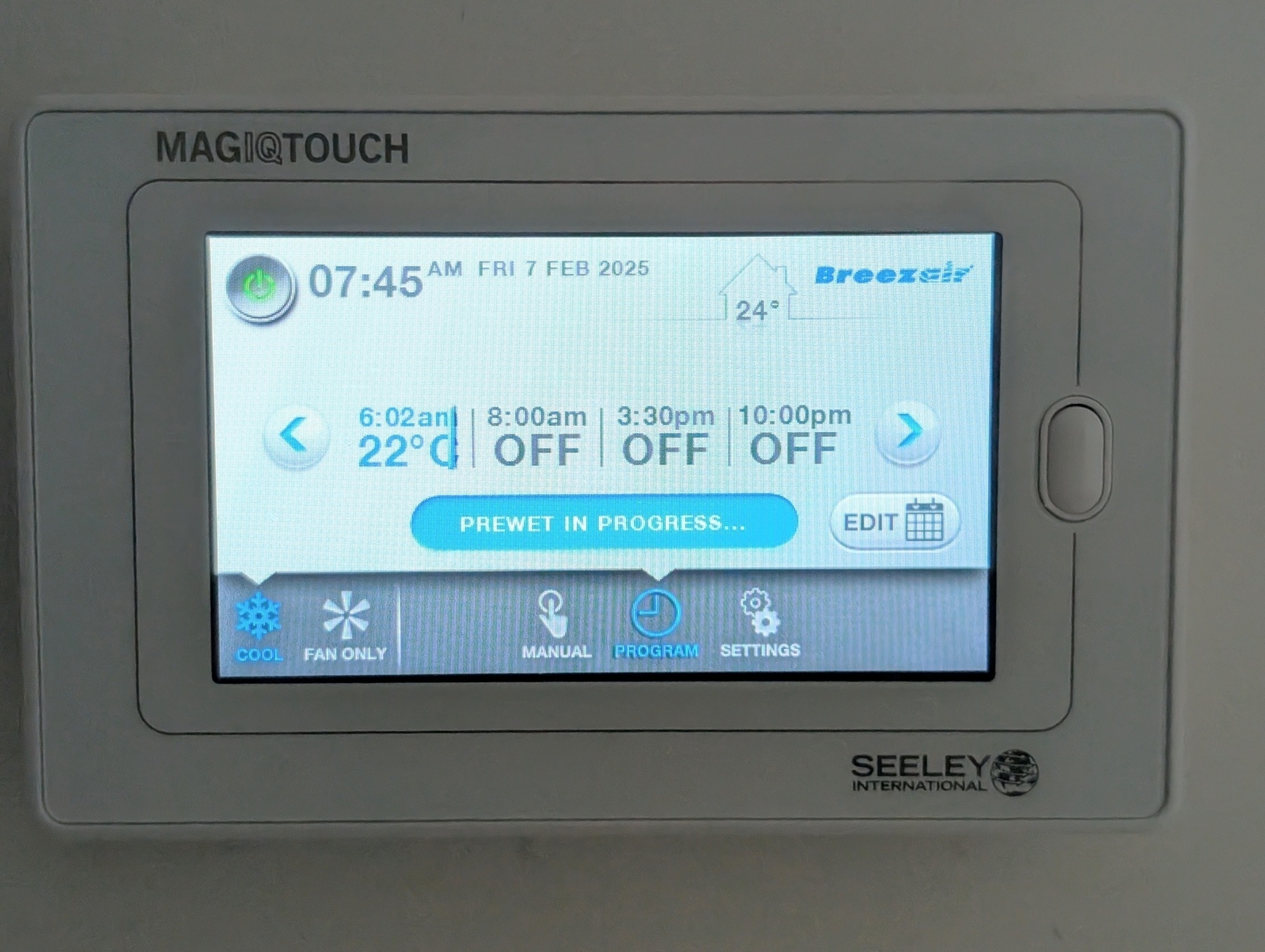 Auto-generated description: A Seeley International MagiQtouch controller displays temperature settings and a schedule for cooling with the message PREWET IN PROGRESS.