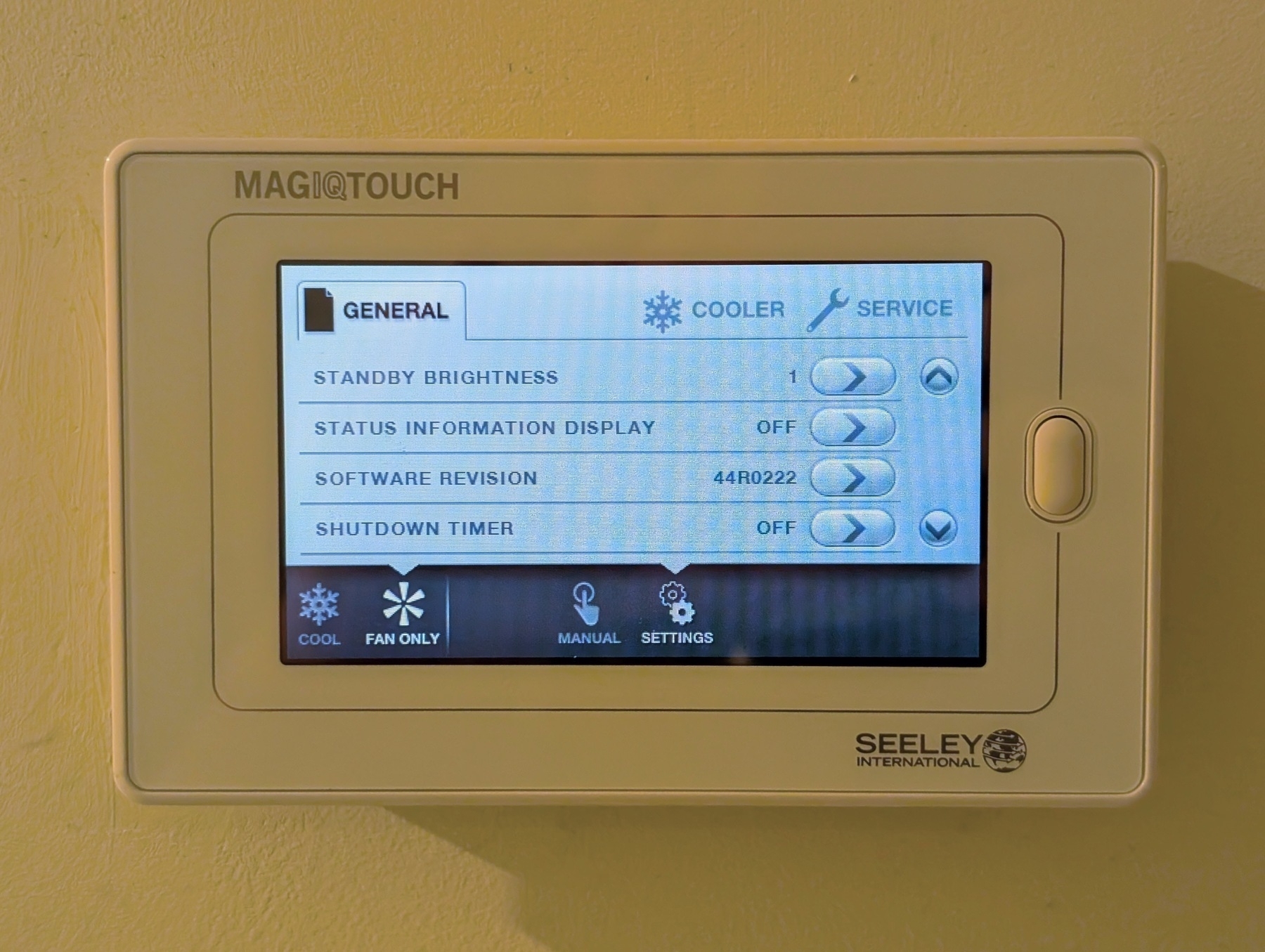 Auto-generated description: A Seeley International MagIQTOUCH control panel displays options for adjusting settings like standby brightness, status information, and shutdown timer.