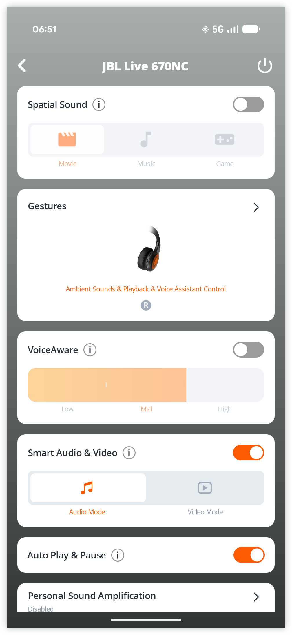 Auto-generated description: A screenshot from a mobile app interface shows settings for a JBL Live 670NC device, including options for spatial sound, gestures, voice awareness, audio and video modes, and personal sound amplification.