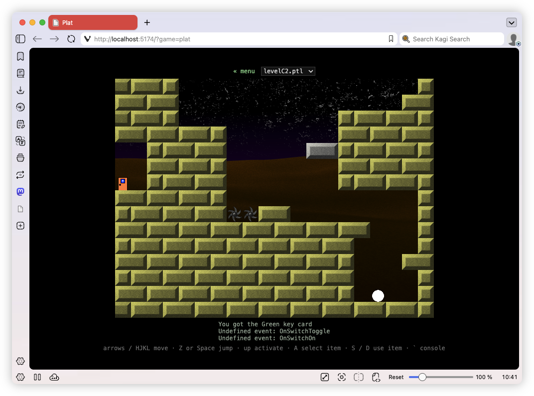 Auto-generated description: A pixelated platform game level is shown on a web browser with a character next to a green key card and white ball on a stone brick-style terrain against a night sky backdrop.