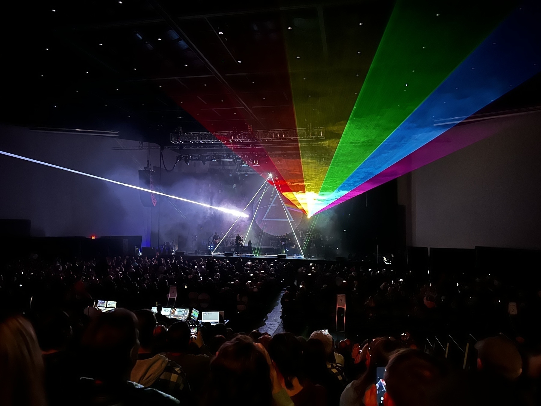 Brit Floyd in concert, depicting the Dark Side of the Moon prism cover, also repeated with laser light.