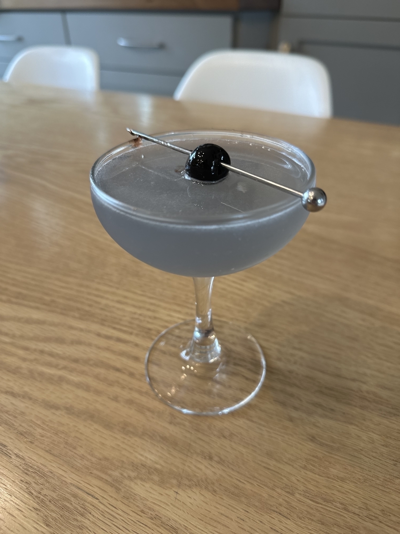 Aviation cocktail with cherry garnish