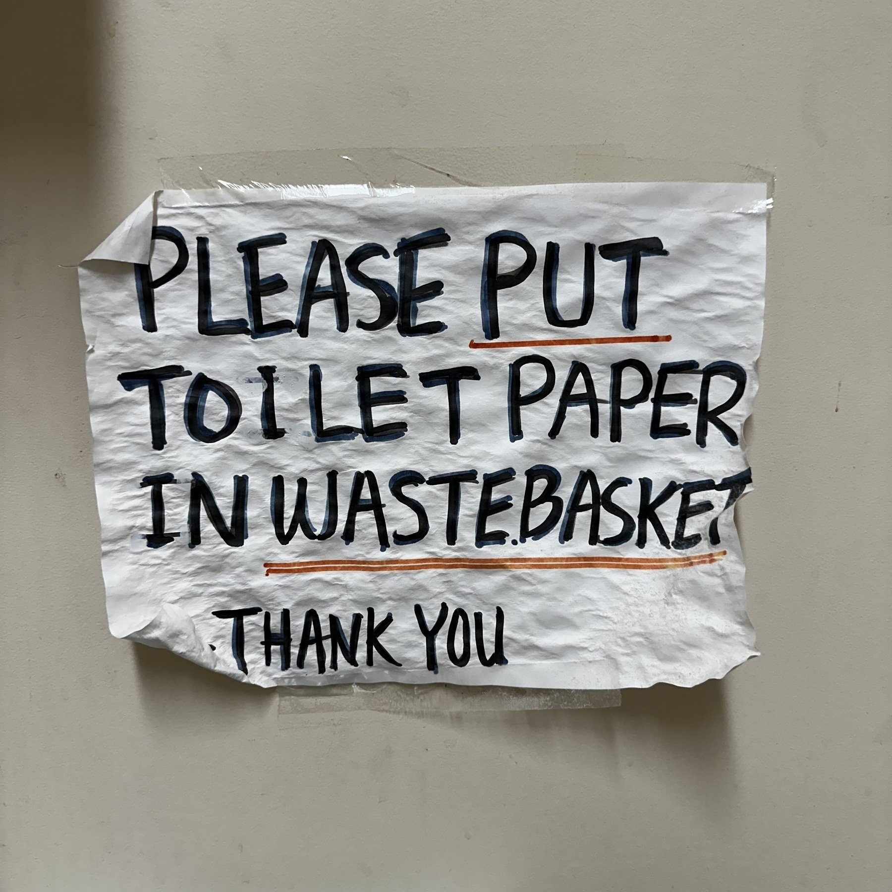 Bathroom sign that reads: please put toilet paper in the wastebasket. Thank you.