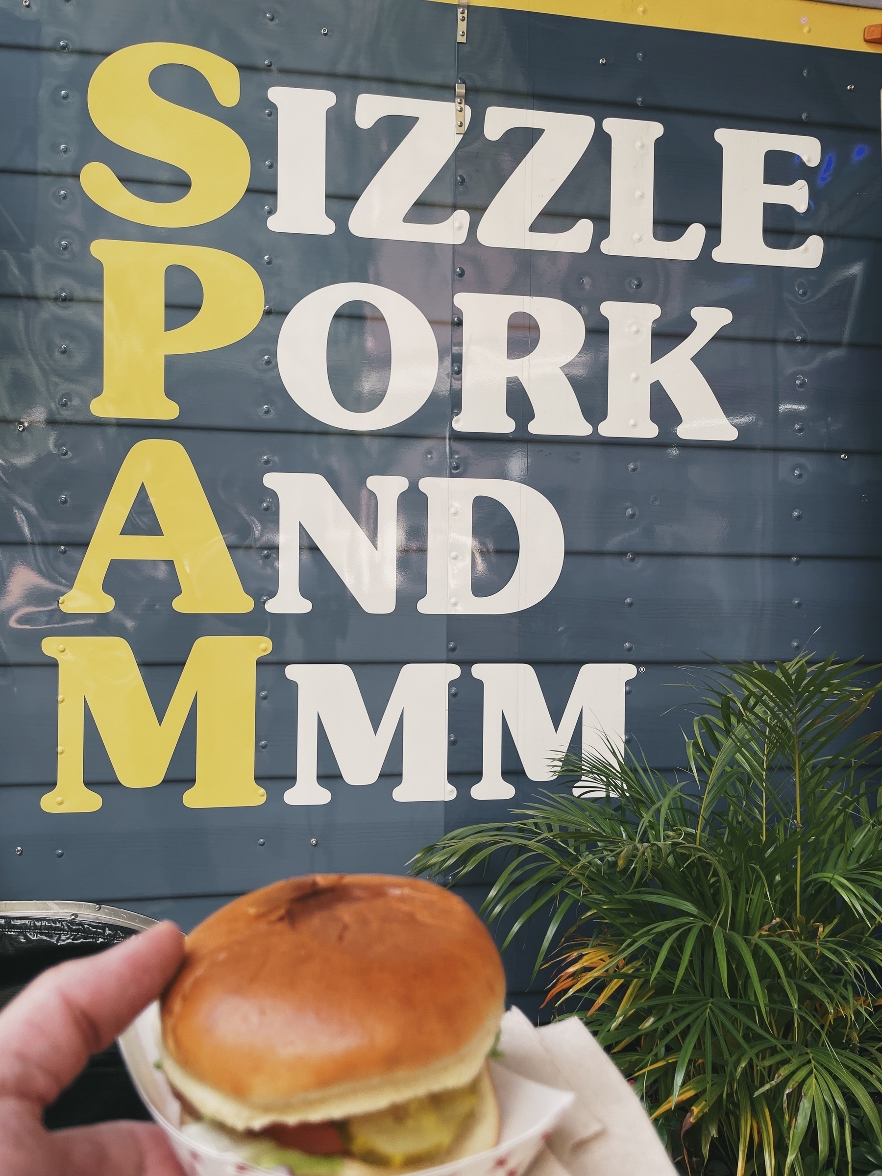 SPAM Burger positioned in front of vendor sign