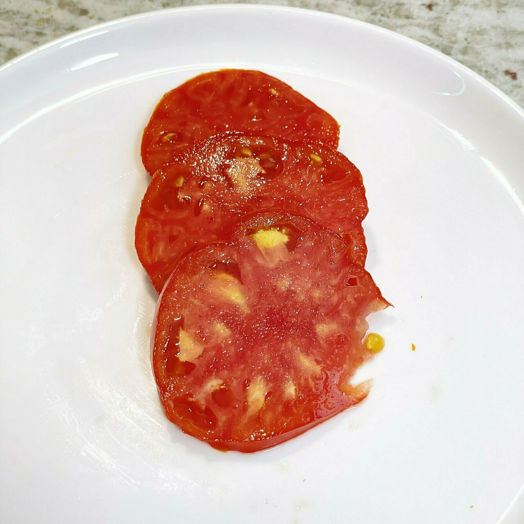 bright-red-tomato-on-white-plate.jpeg