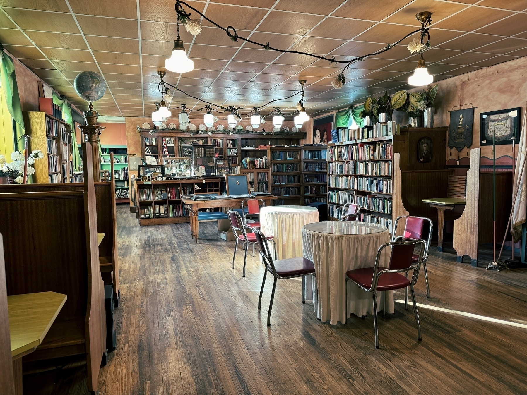 interior of bookstore lined with old books and classics, in what appears to be a hybrid bookstore and restaurant with booths