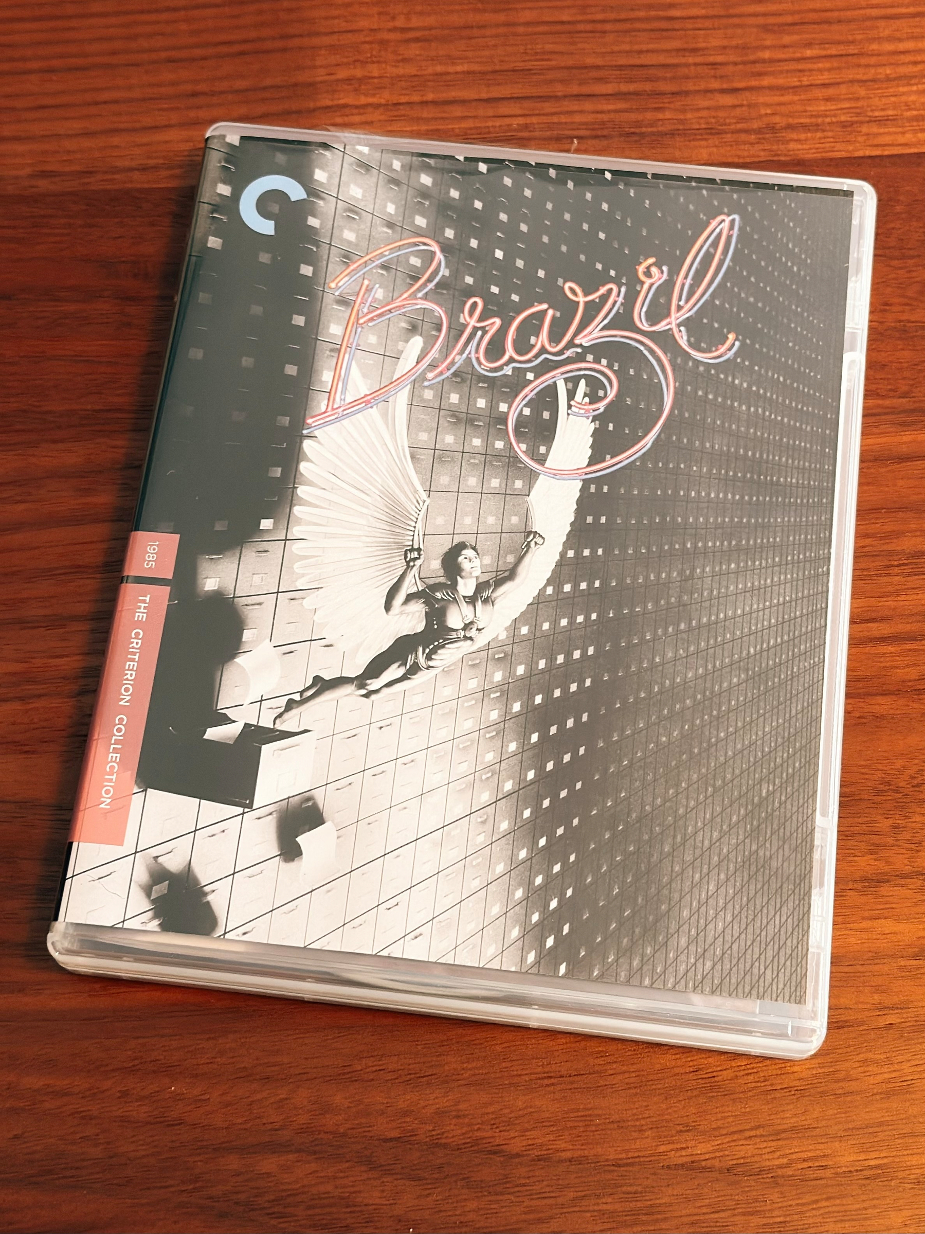 A Criterion Collection case for the film Brazil is placed on a wooden surface.