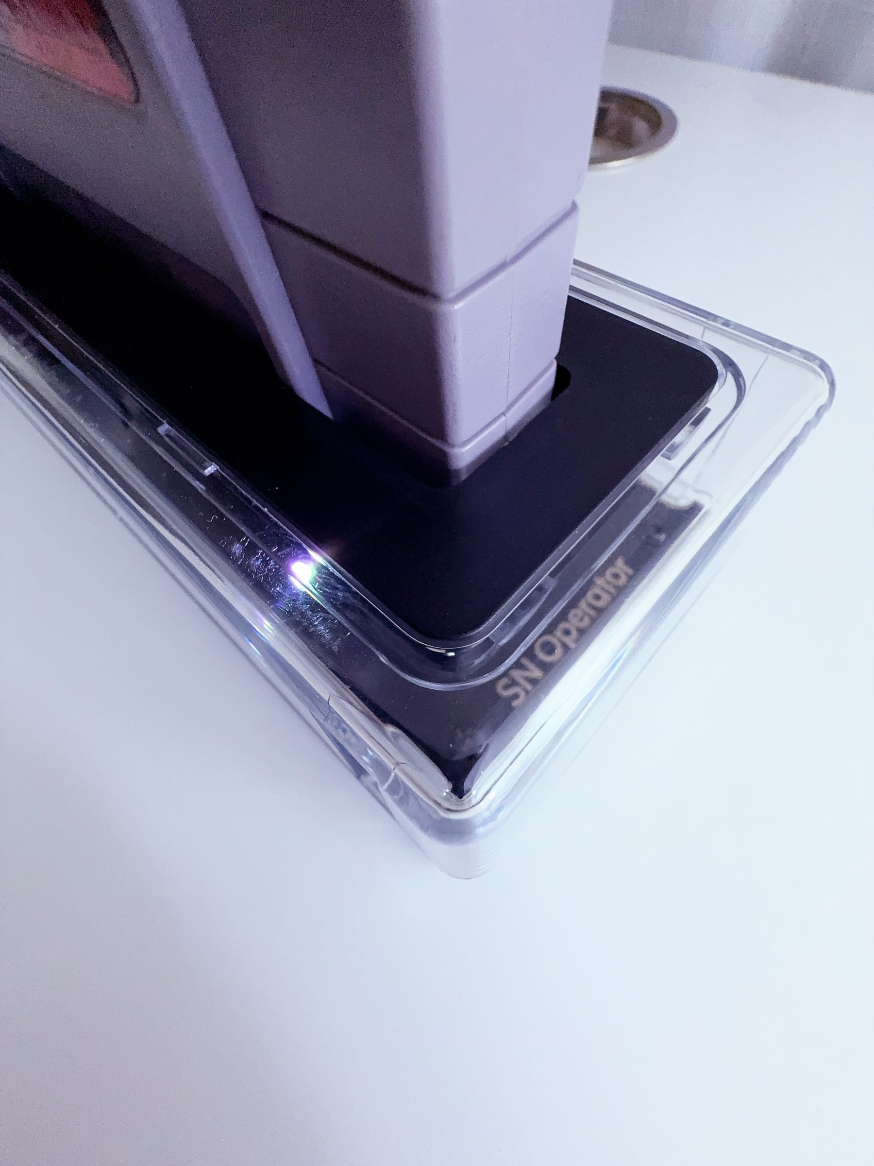 A translucent hardware device close up on the text inside of the plastic, reading 'SN Operator' 