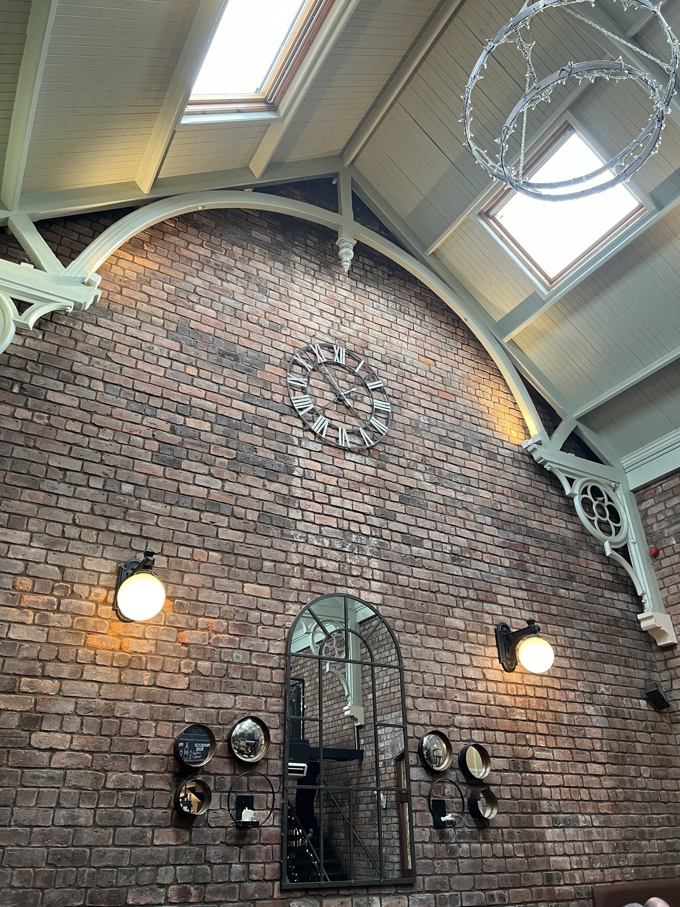 High ceiling, Brick wall with a large clock 