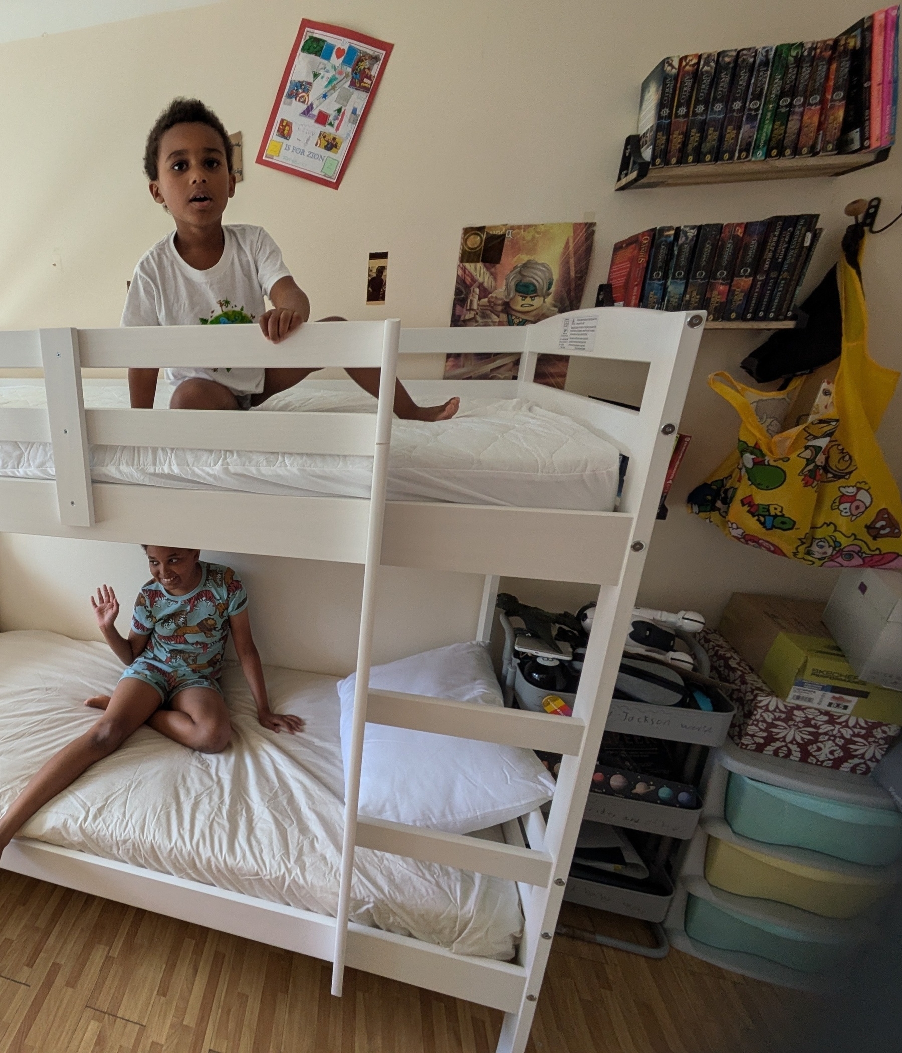 Two happy kids on their new bunk beds