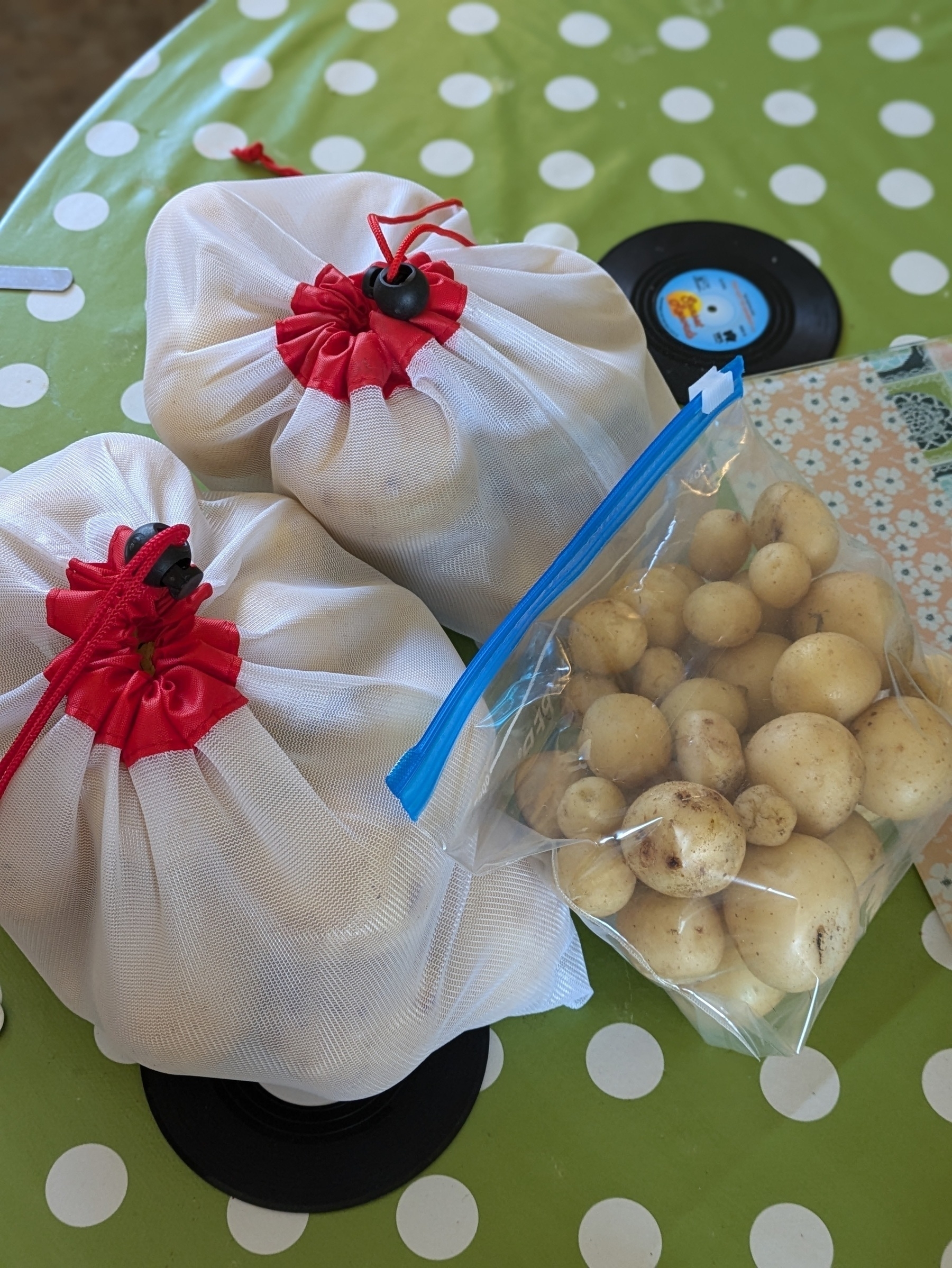 Three bags of potatoes on the kitchen table 