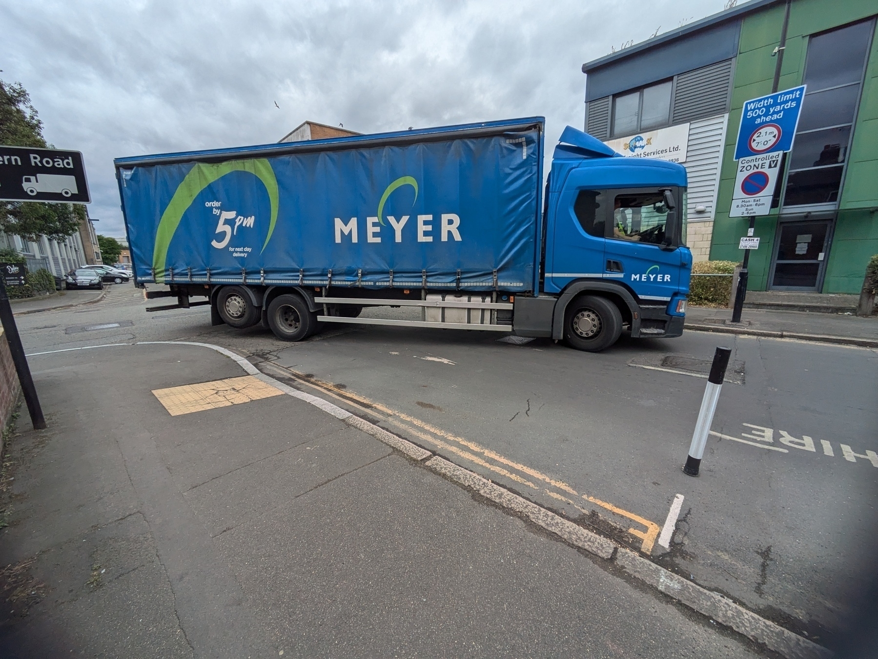 Photo of Heavy Hoods Vehicle cutting the corner and turning in towards the new active travel infrastructure of the previous photo