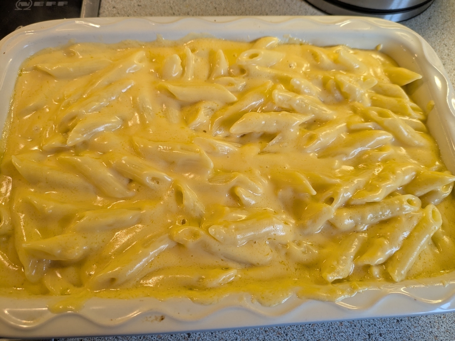 A casserole dish filled with creamy baked macaroni and cheese.