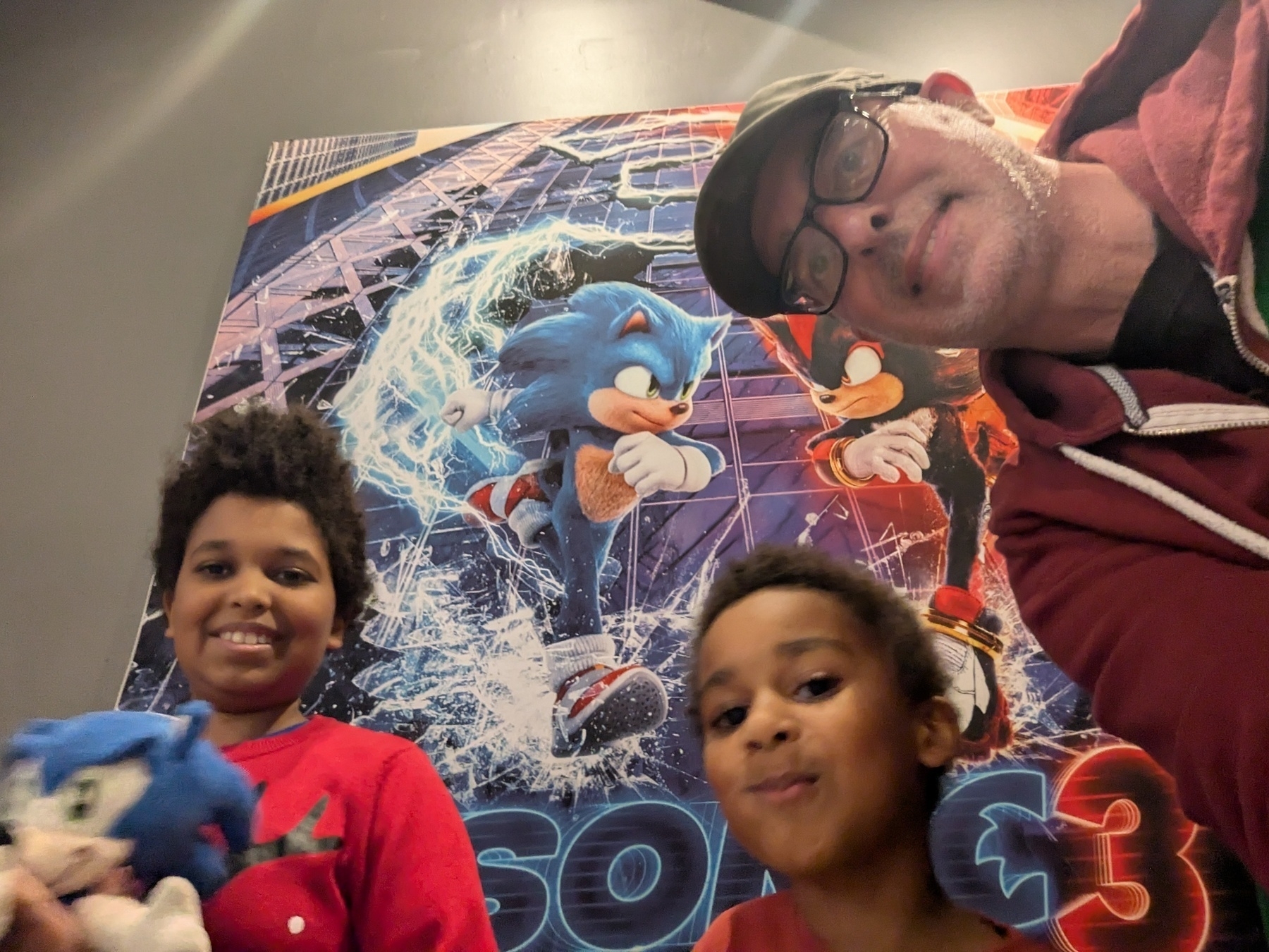 Selfie of big kid, little kid, Dad and Sonic the Hedgehog 3