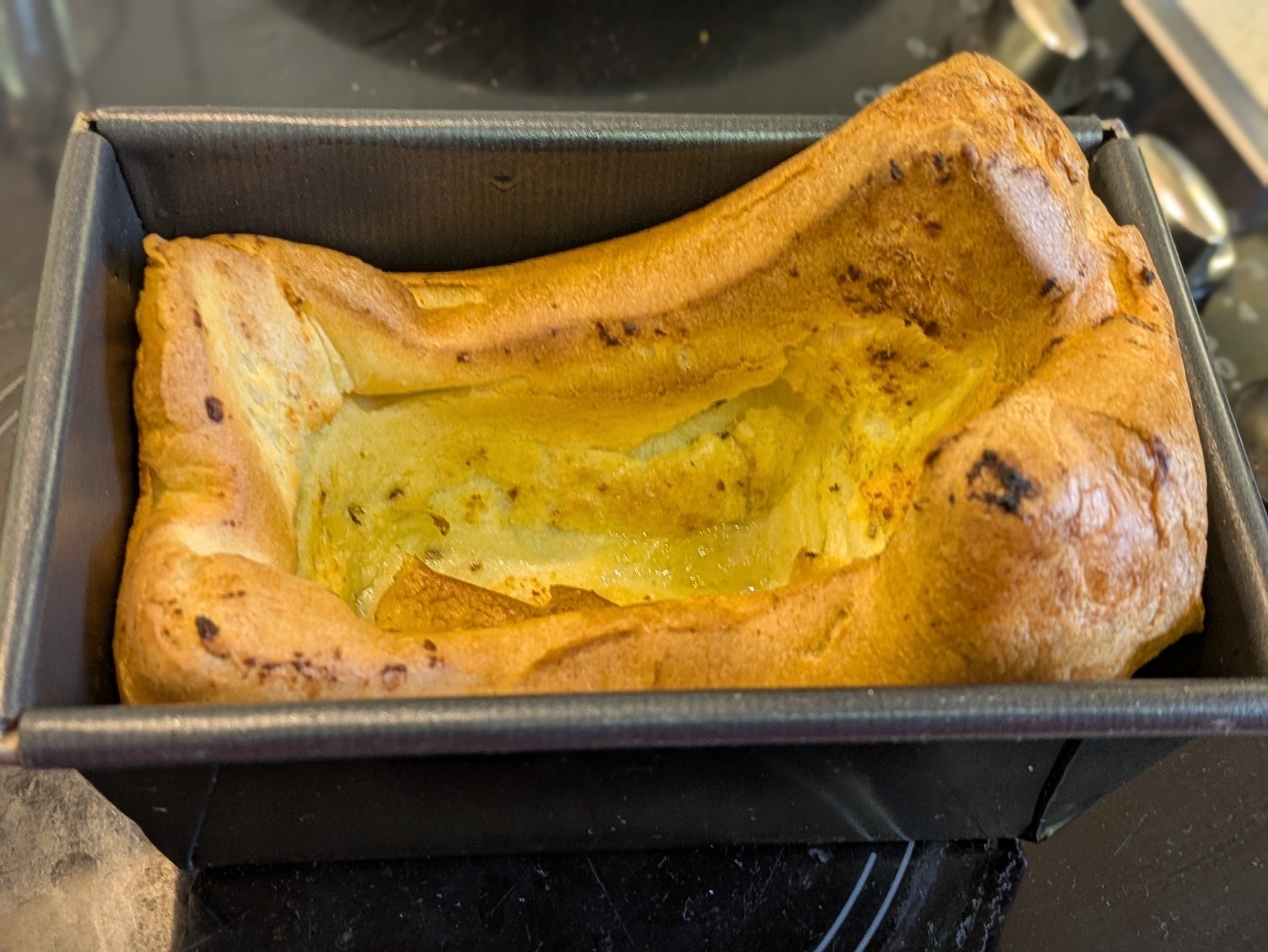 Home made Yorkshire pudding in a small black bread tin