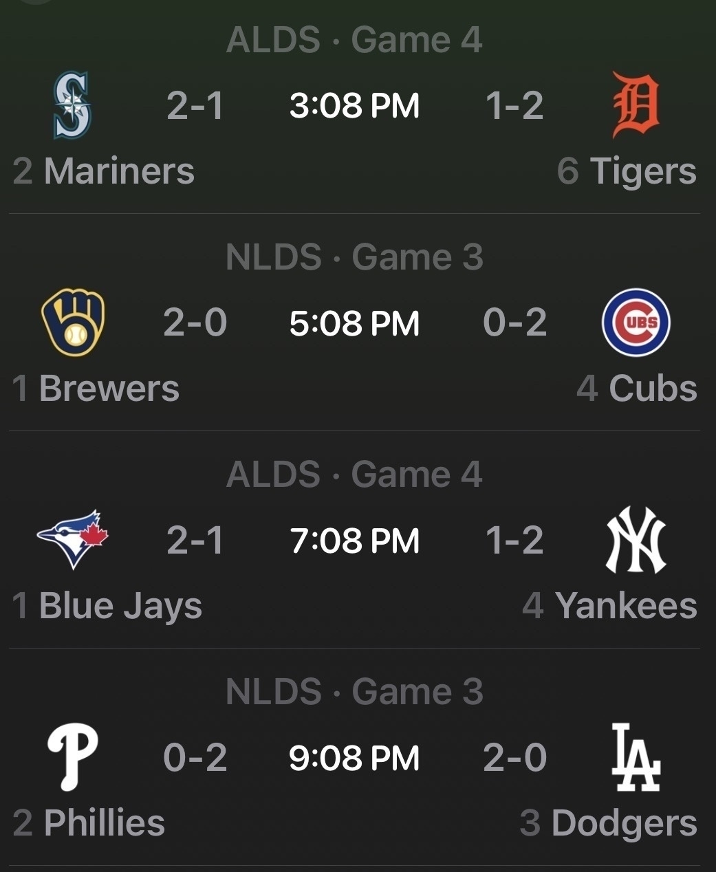 Auto-generated description: A schedule for MLB Division Series games shows matchups between Mariners vs. Tigers, Brewers vs. Cubs, Blue Jays vs. Yankees, and Phillies vs. Dodgers, with current series standings and game times.