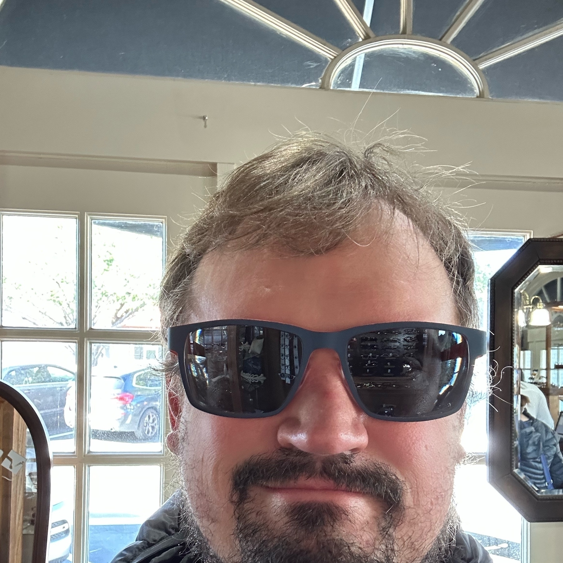 Photo of Grant Hutchins indoors wearing new sunglasses