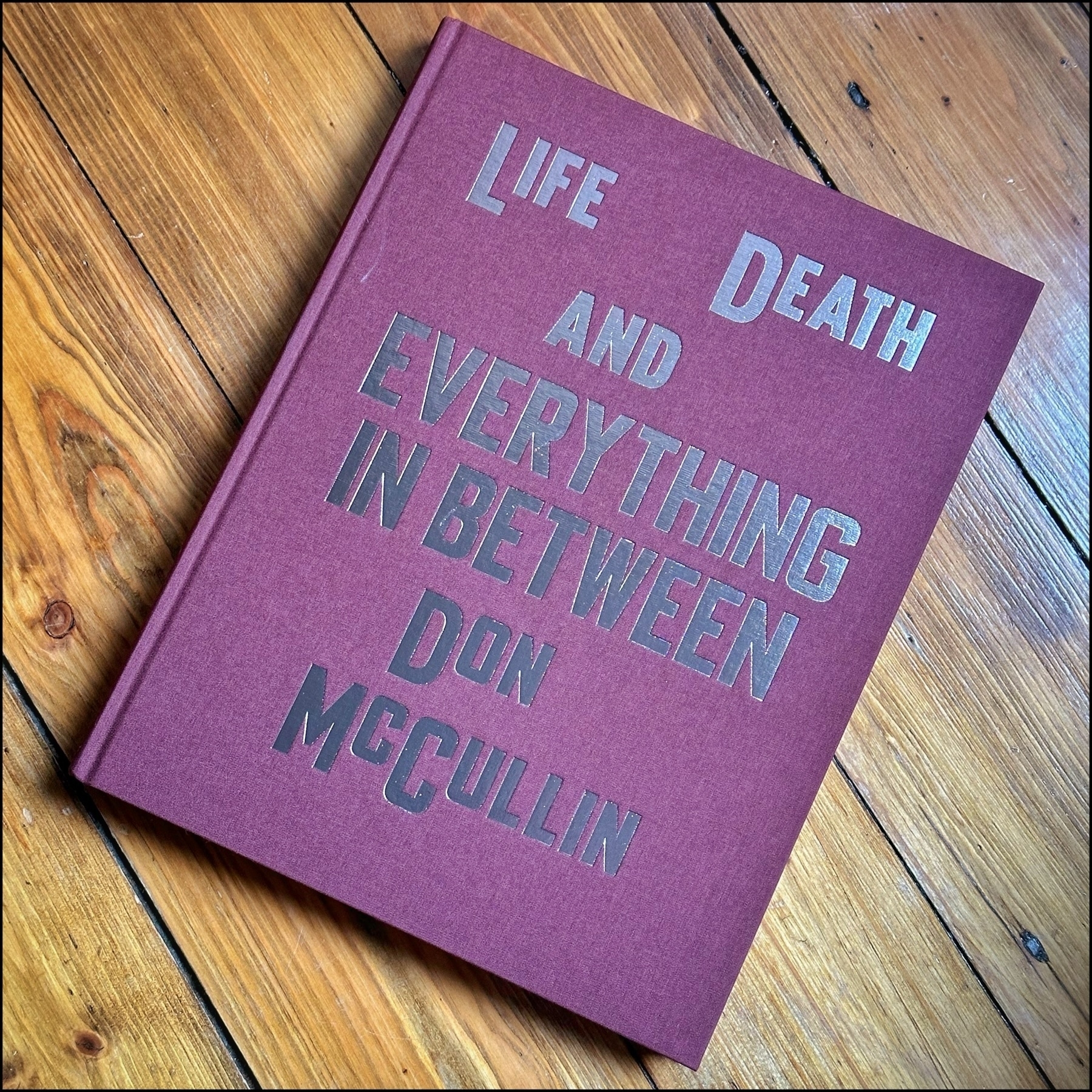 A book with the title "Life and Death and Everything In Between".
